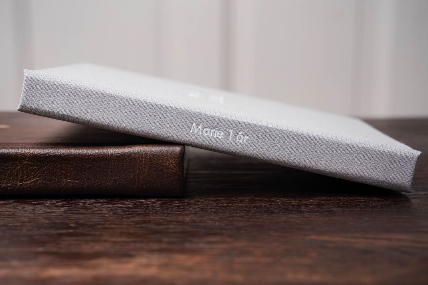 White photo album pages with clean modern design displayed against neutral background.