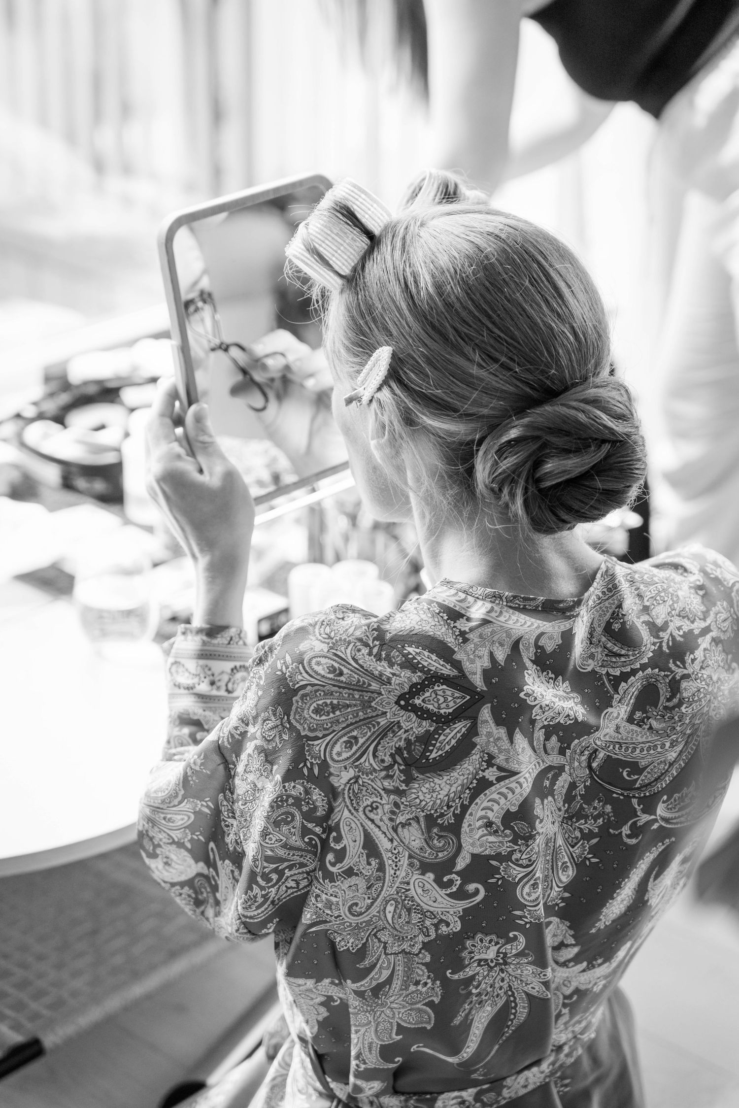 Black and white photo sequence showing someone with an elegant updo hairstyle from different angles.