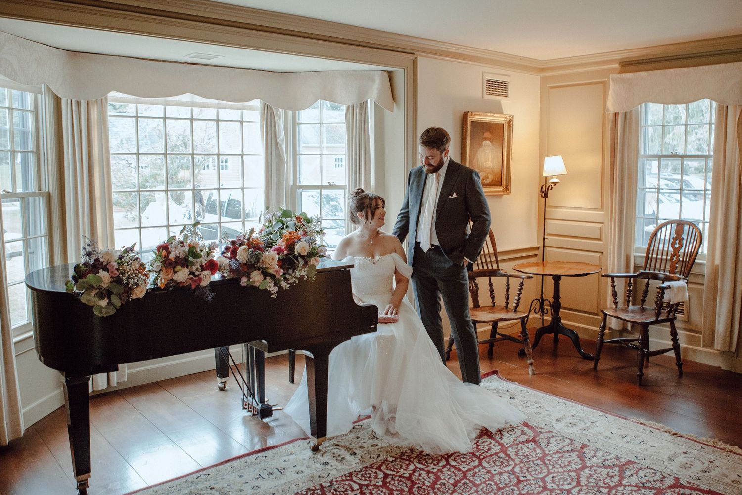 Panoramic view of an elegant wedding venue room with large windows and classic furnishings.