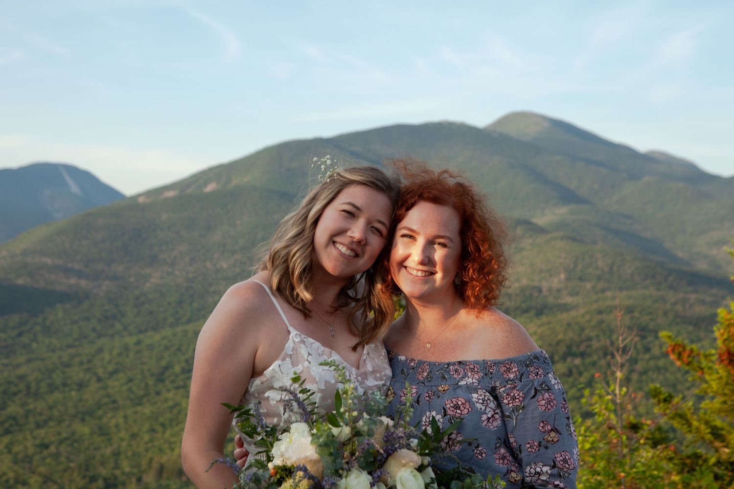 Mountain landscape provides scenic backdrop for wedding photos at sunset.