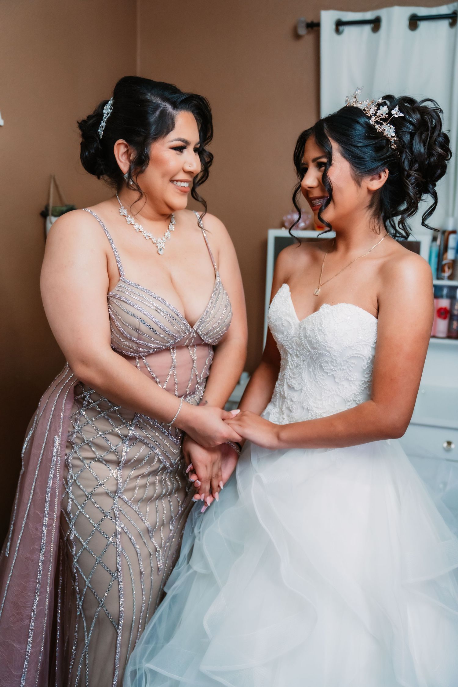 Wedding party getting ready scene showing sparkly beaded dress and white gown details.