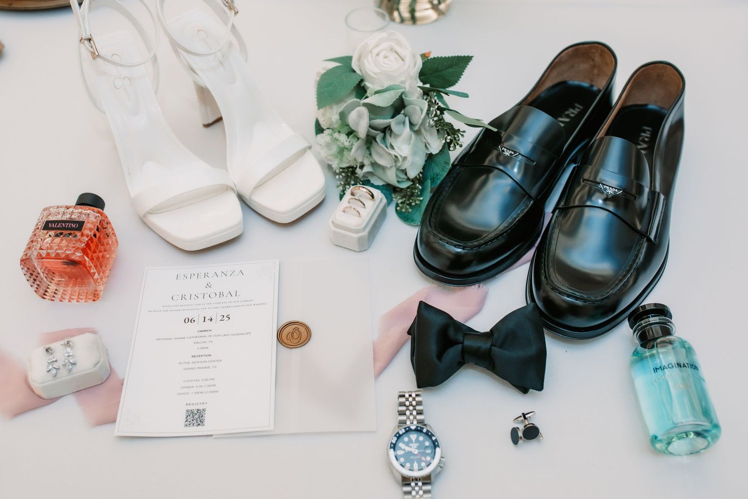 Wedding accessories including shoes, invitations, and decorative elements arranged on white surface.