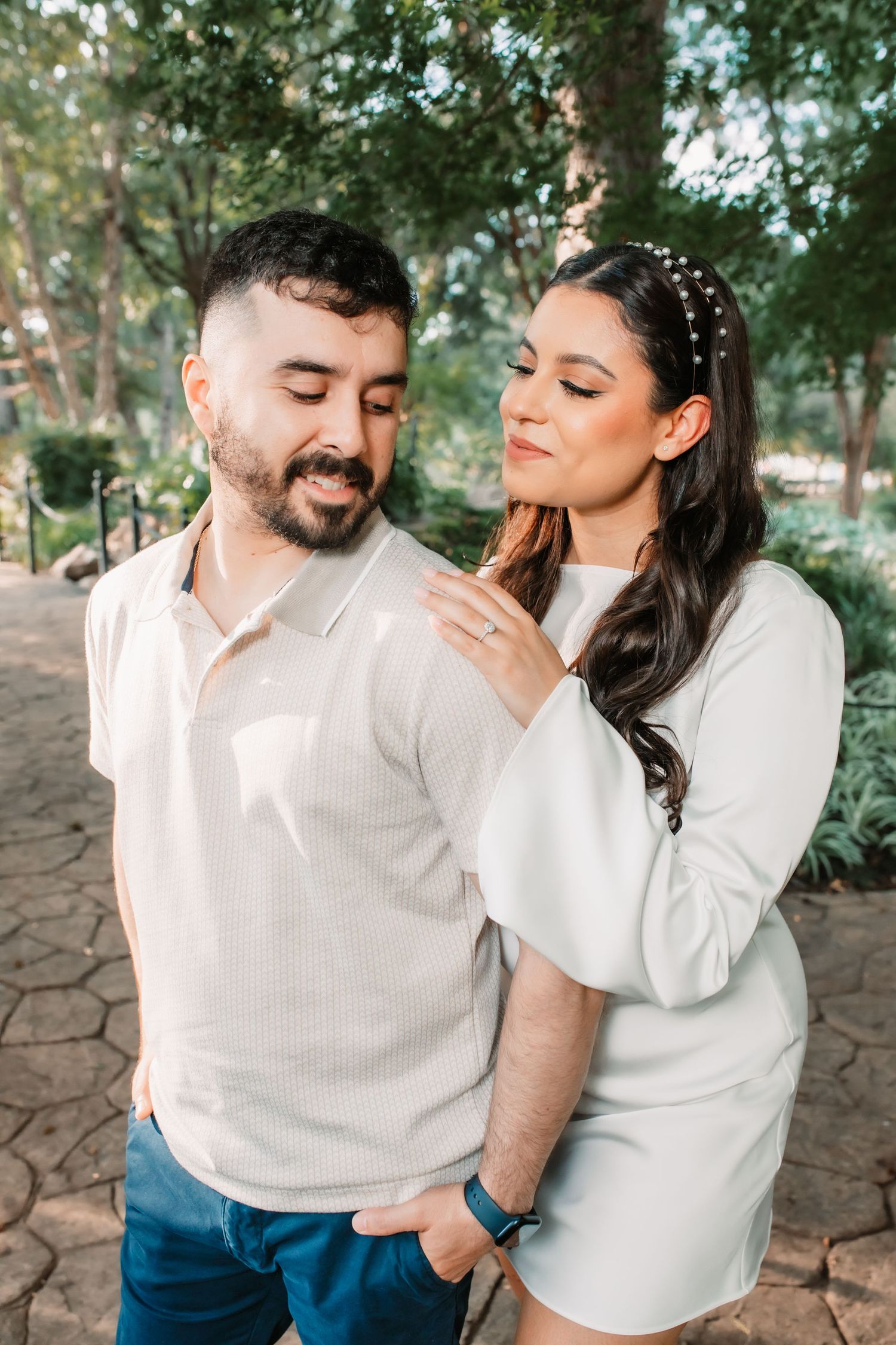Intimate engagement photos captured in a natural outdoor setting.