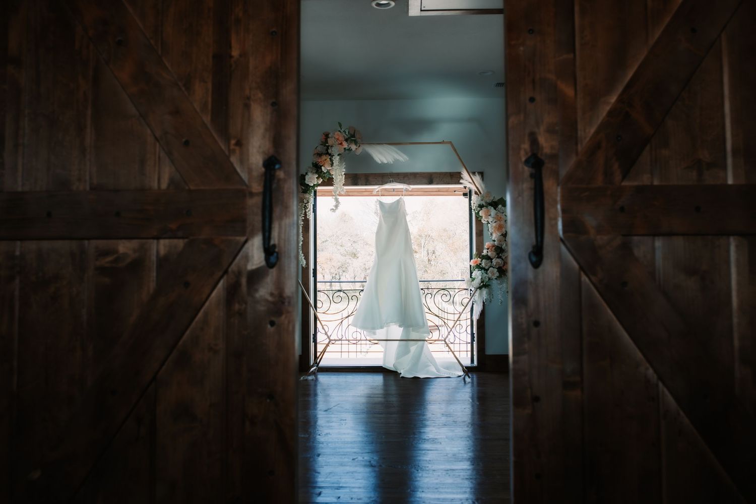 Elegant wedding venue interior with wrought iron railings and natural light streaming through windows.