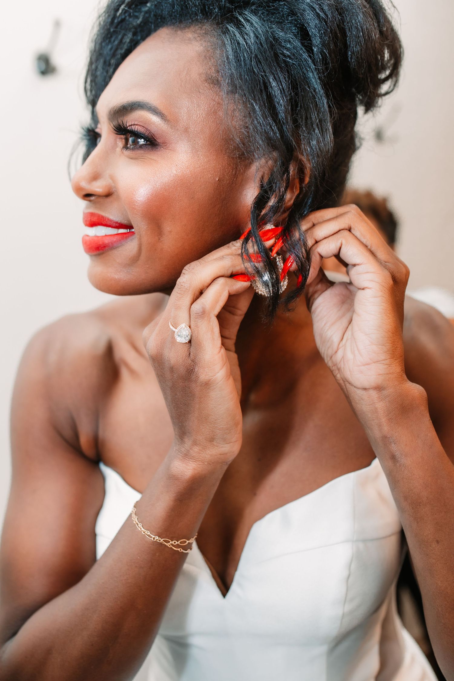 Bridal preparation shots showing jewelry and final touches being added.
