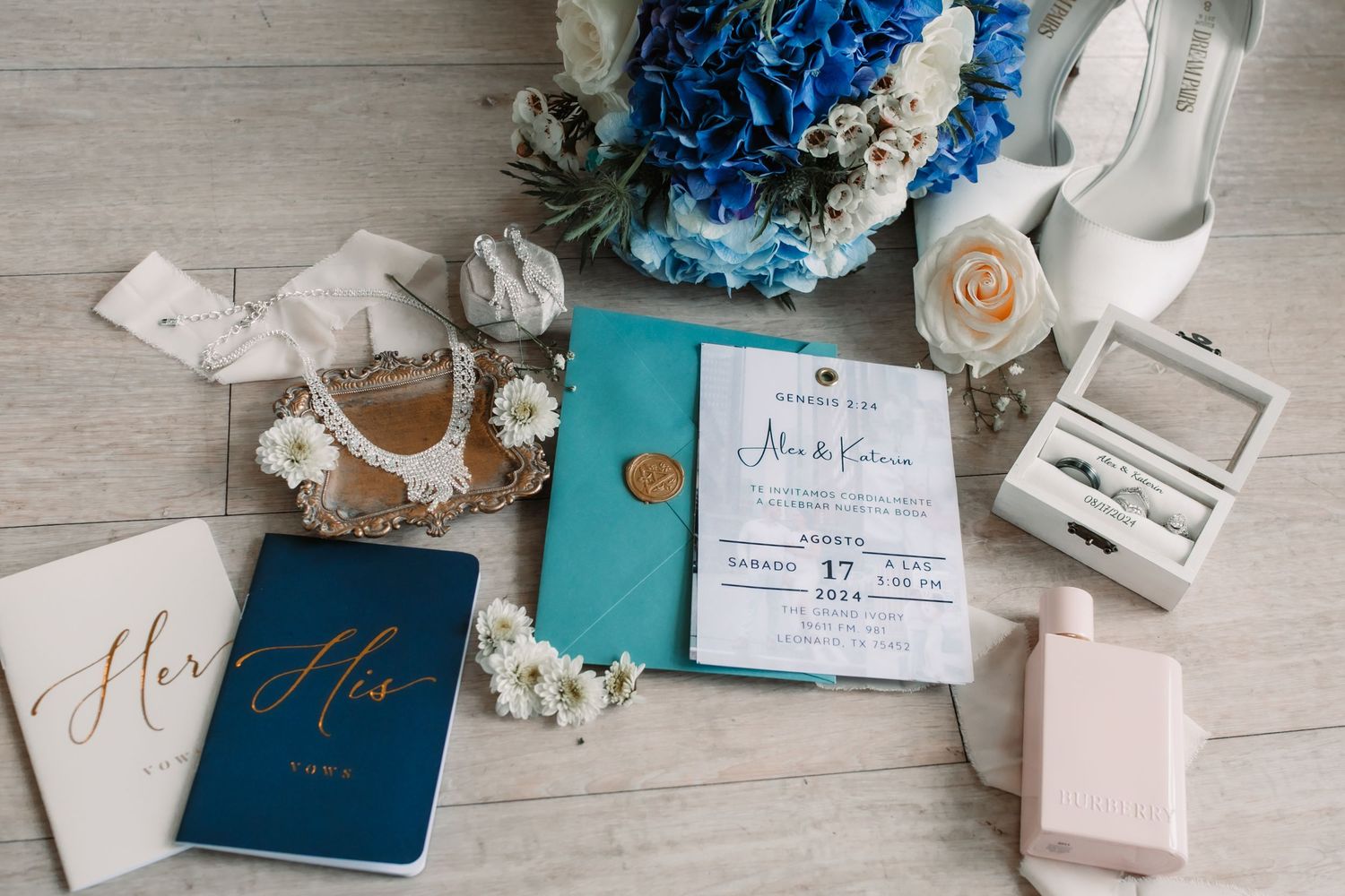 Wedding stationery suite in navy blue and blush tones with floral accents.