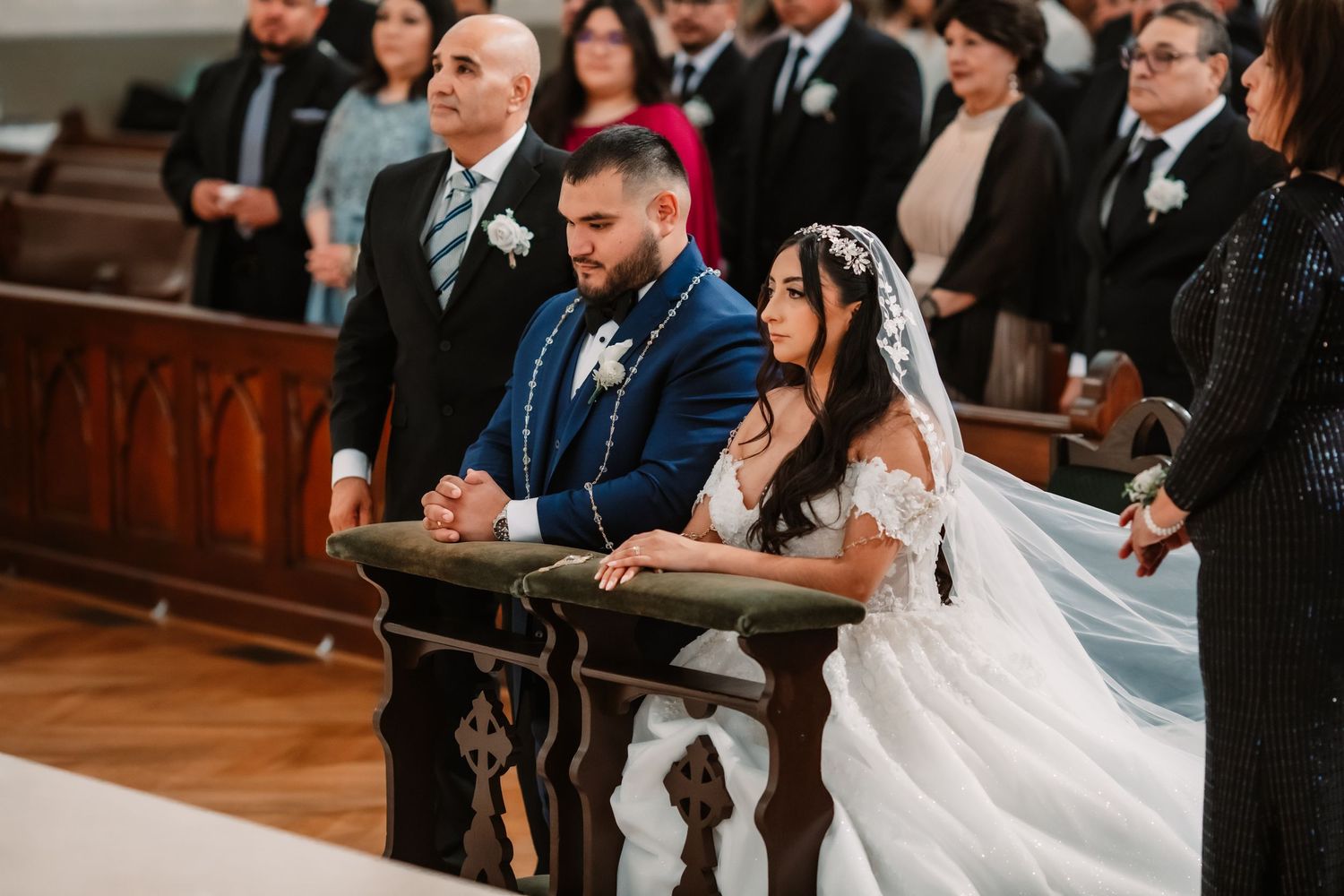 A couple kneels at the altar during their traditional church wedding ceremony.