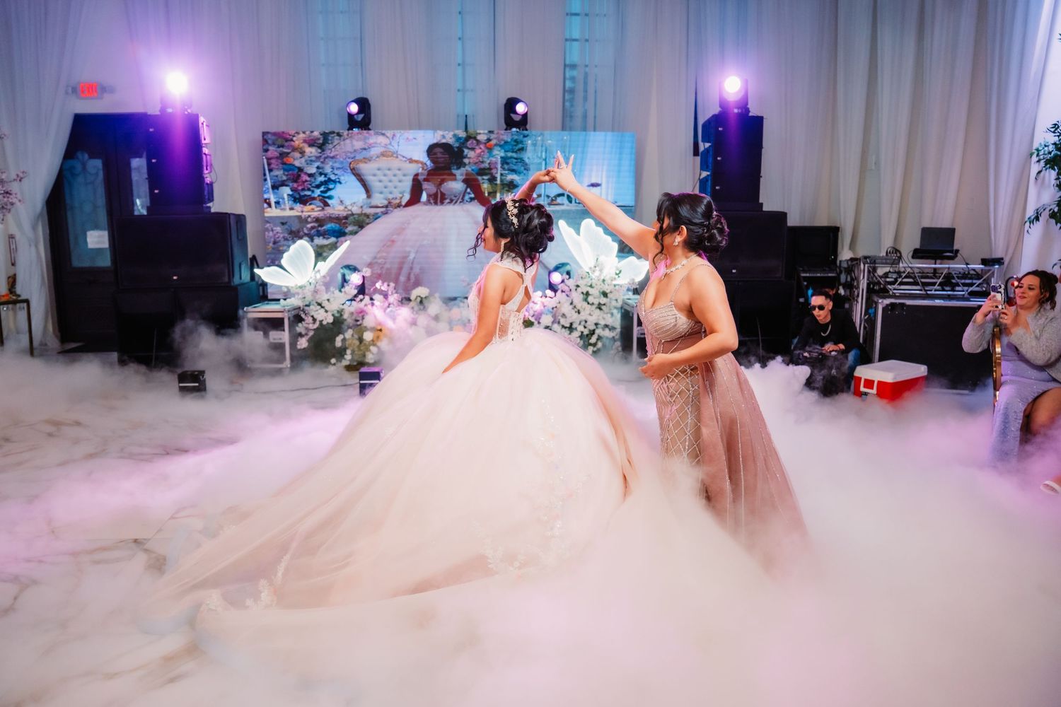Elegant wedding reception venue with purple lighting and fog effects on the dance floor.