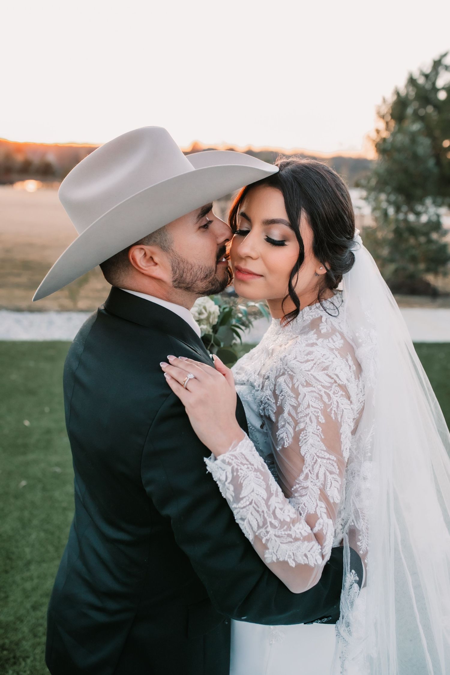 Intimate wedding couple portrait session during golden hour outdoors.