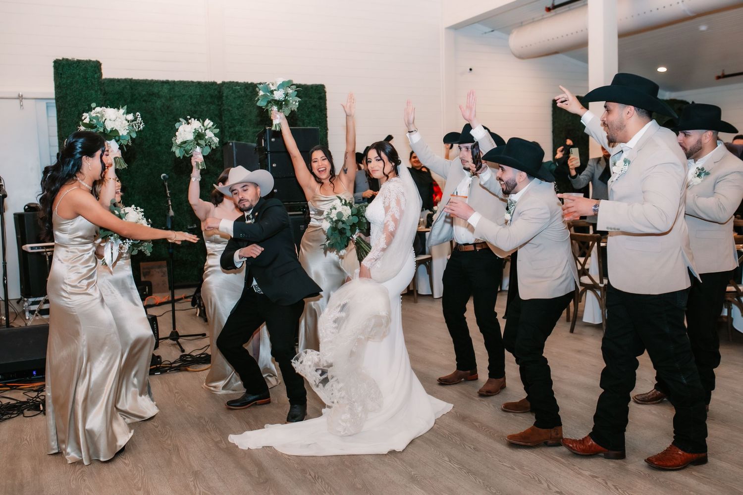 Wedding reception celebration with dancing and festivities indoors.