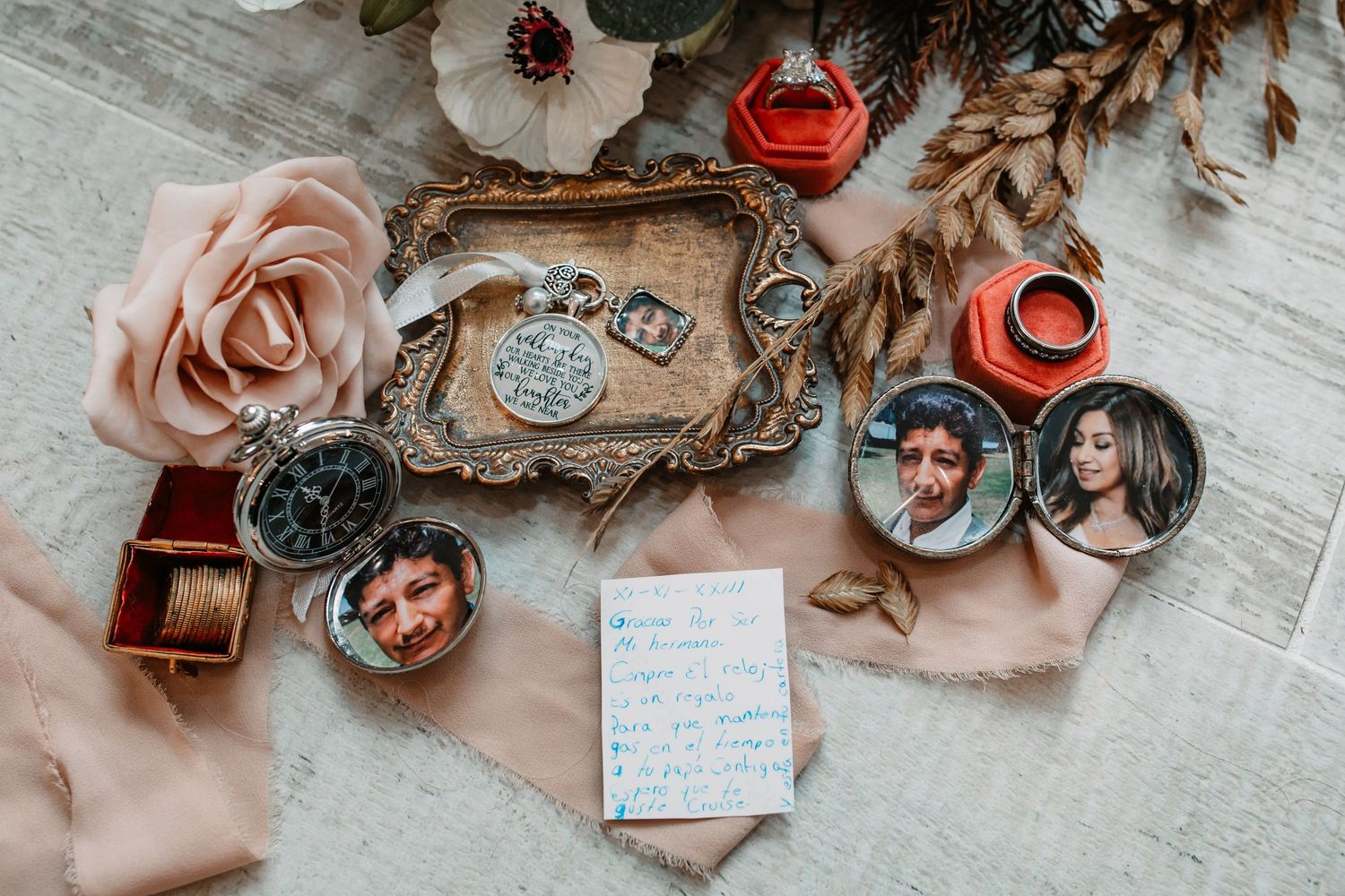 Wedding details flat lay with vintage tray, roses, and decorative elements.