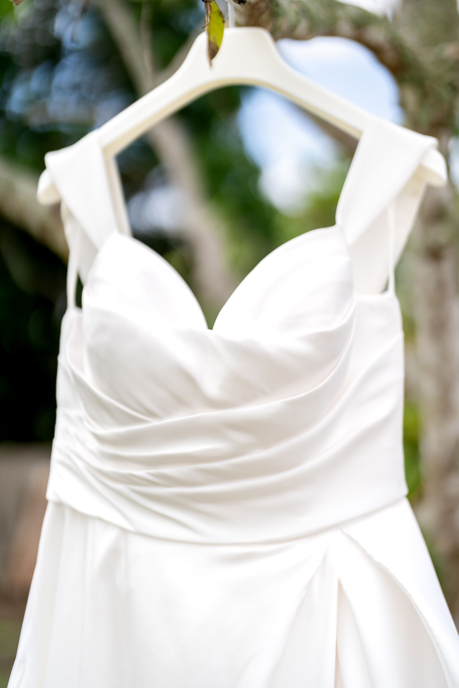 Wedding dress hanging outdoors before the ceremony