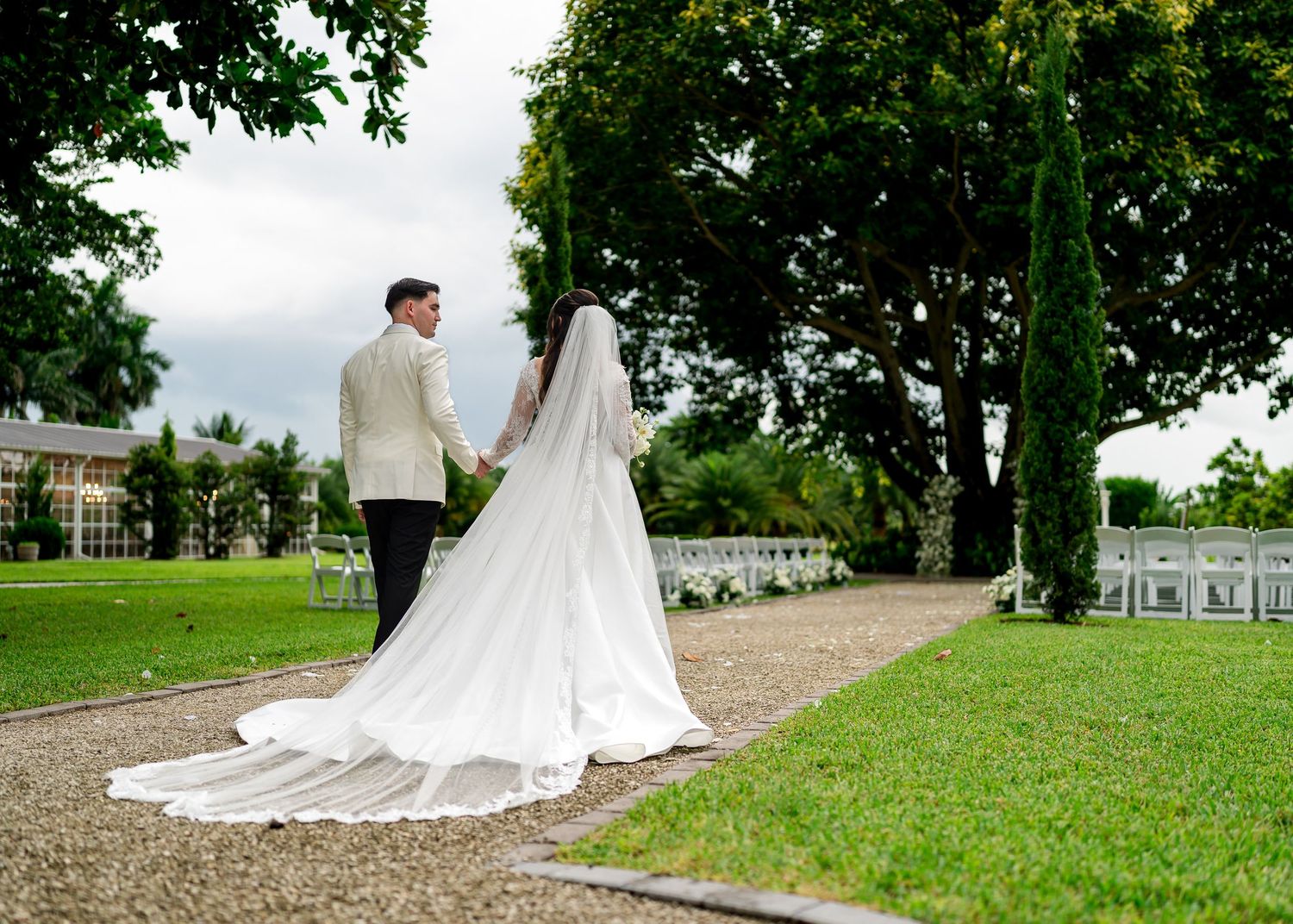 Bride and groom walking together through a garden during their Florida wedding