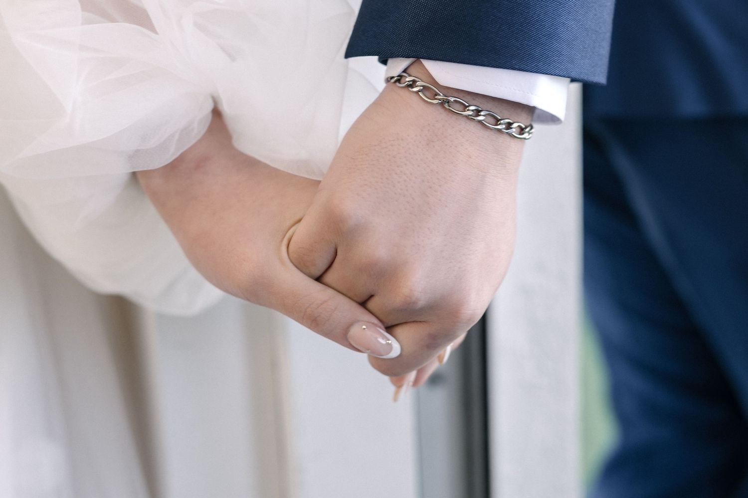 Close-up of bride and groom holding hands during a Miami wedding