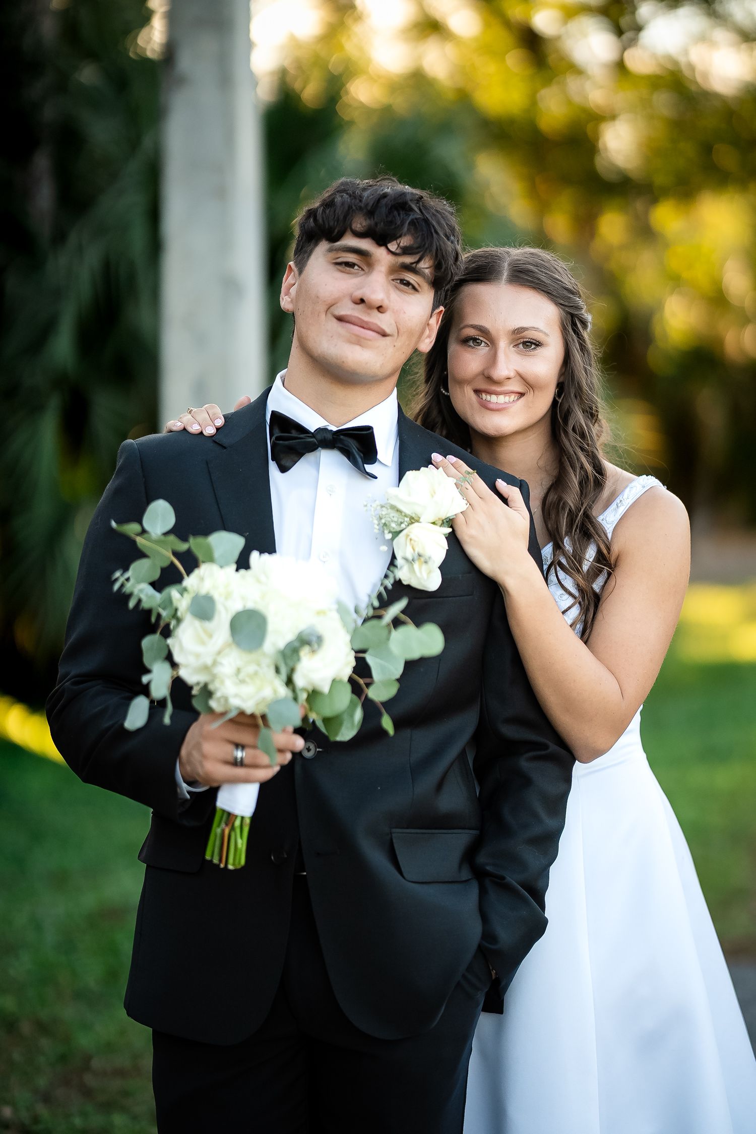 Bride and groom posing together outdoors during their Florida wedding