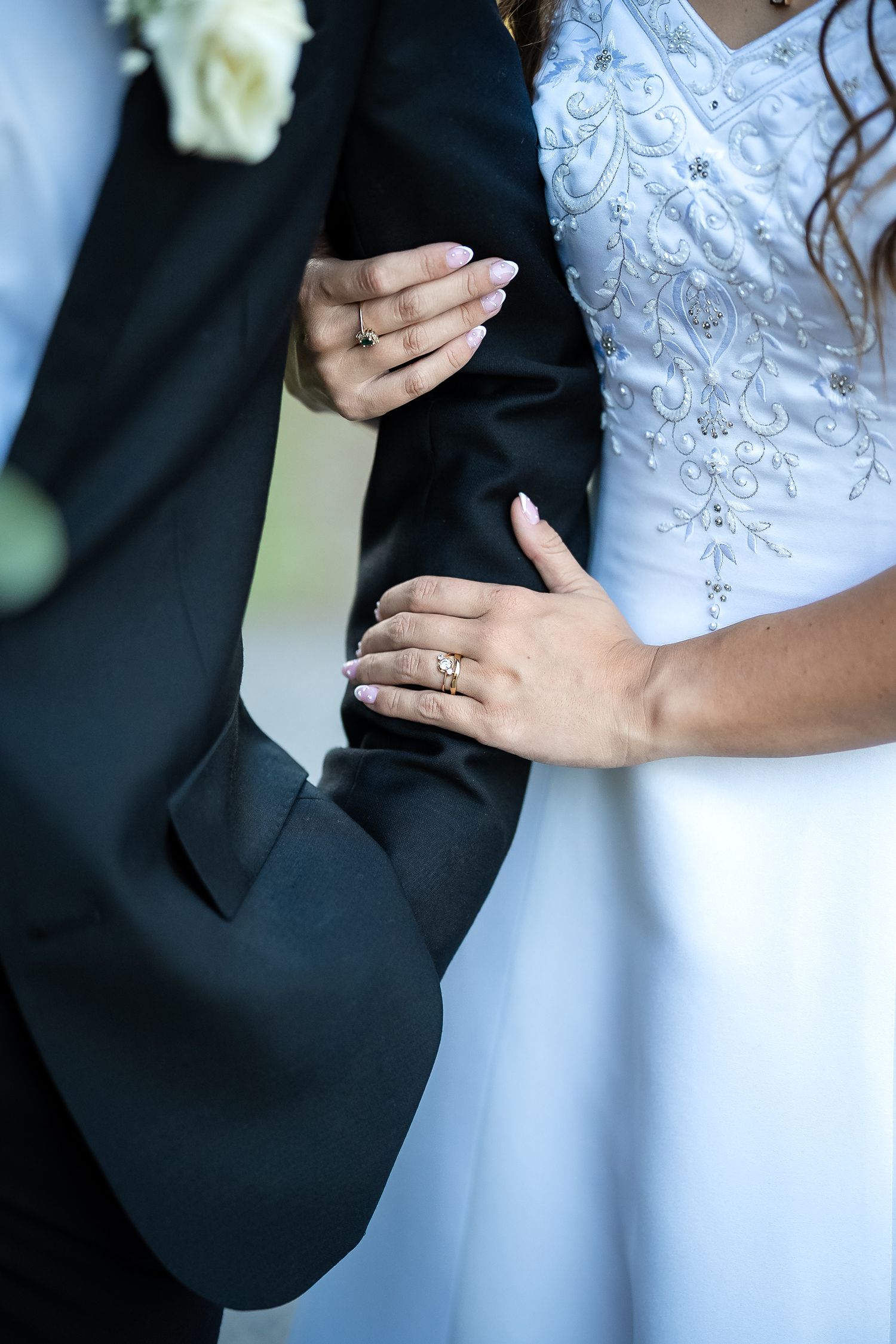 Close-up of bride and groom holding each other during their wedding portraits