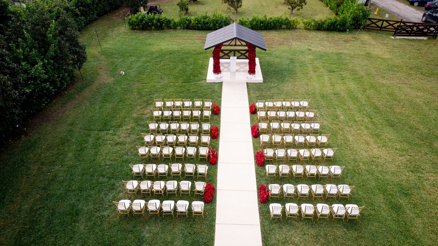 Aerial view of wedding ceremony seating leading to an outdoor gazebo
