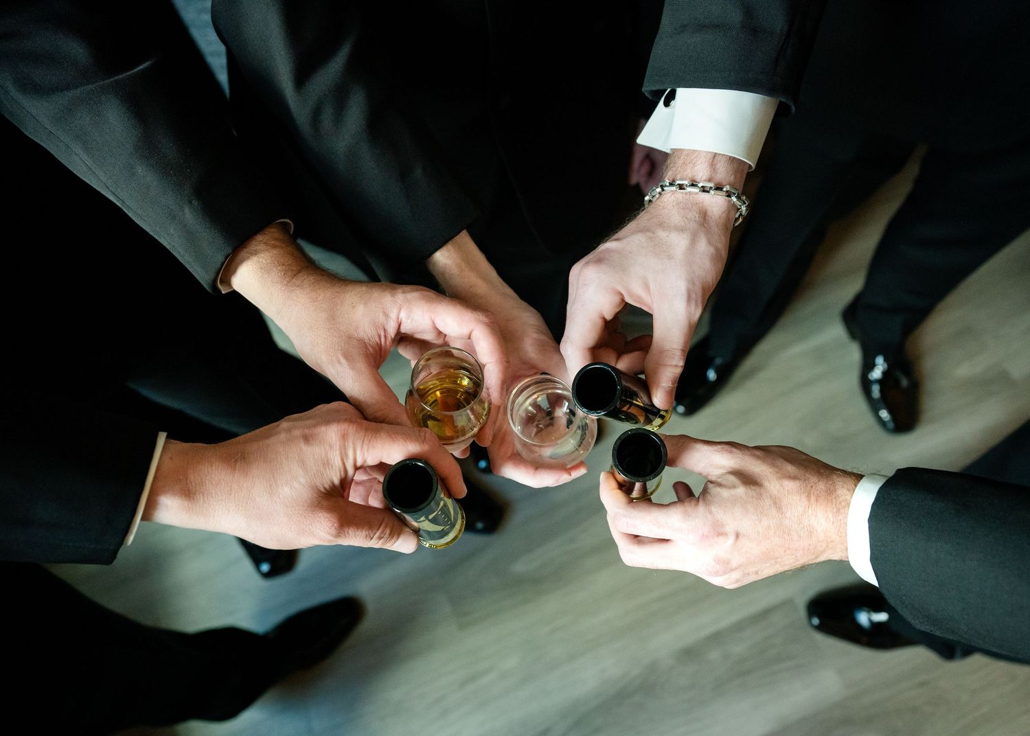 Wedding party raising glasses together during wedding preparations