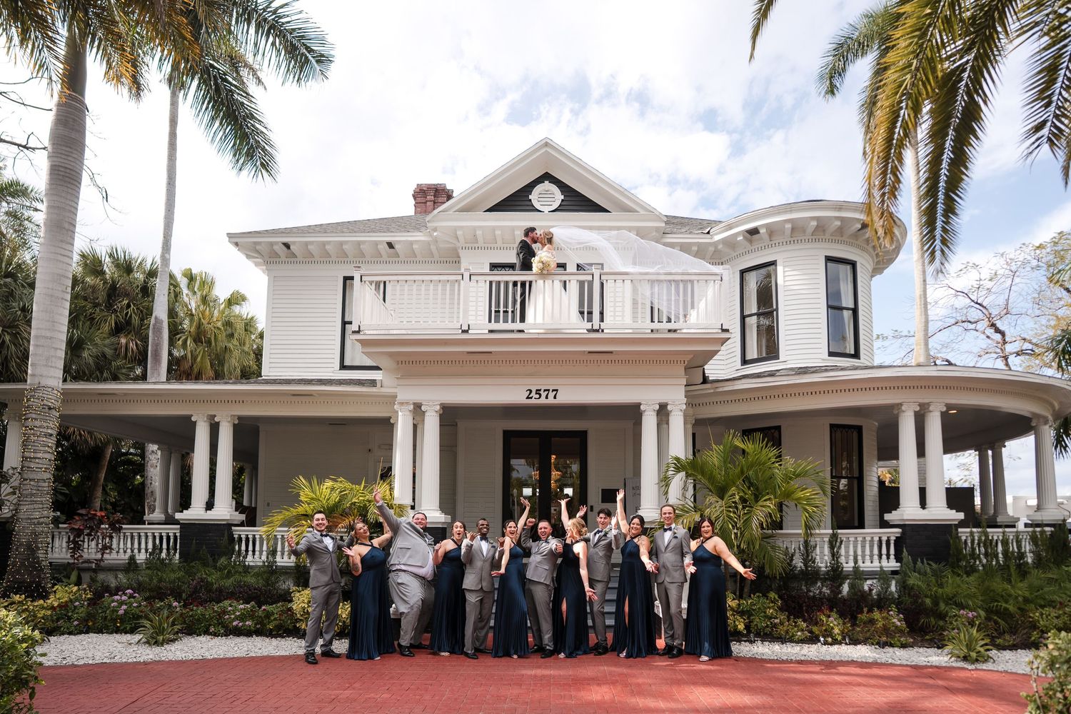 Wedding party posing together outside a historic Florida mansion