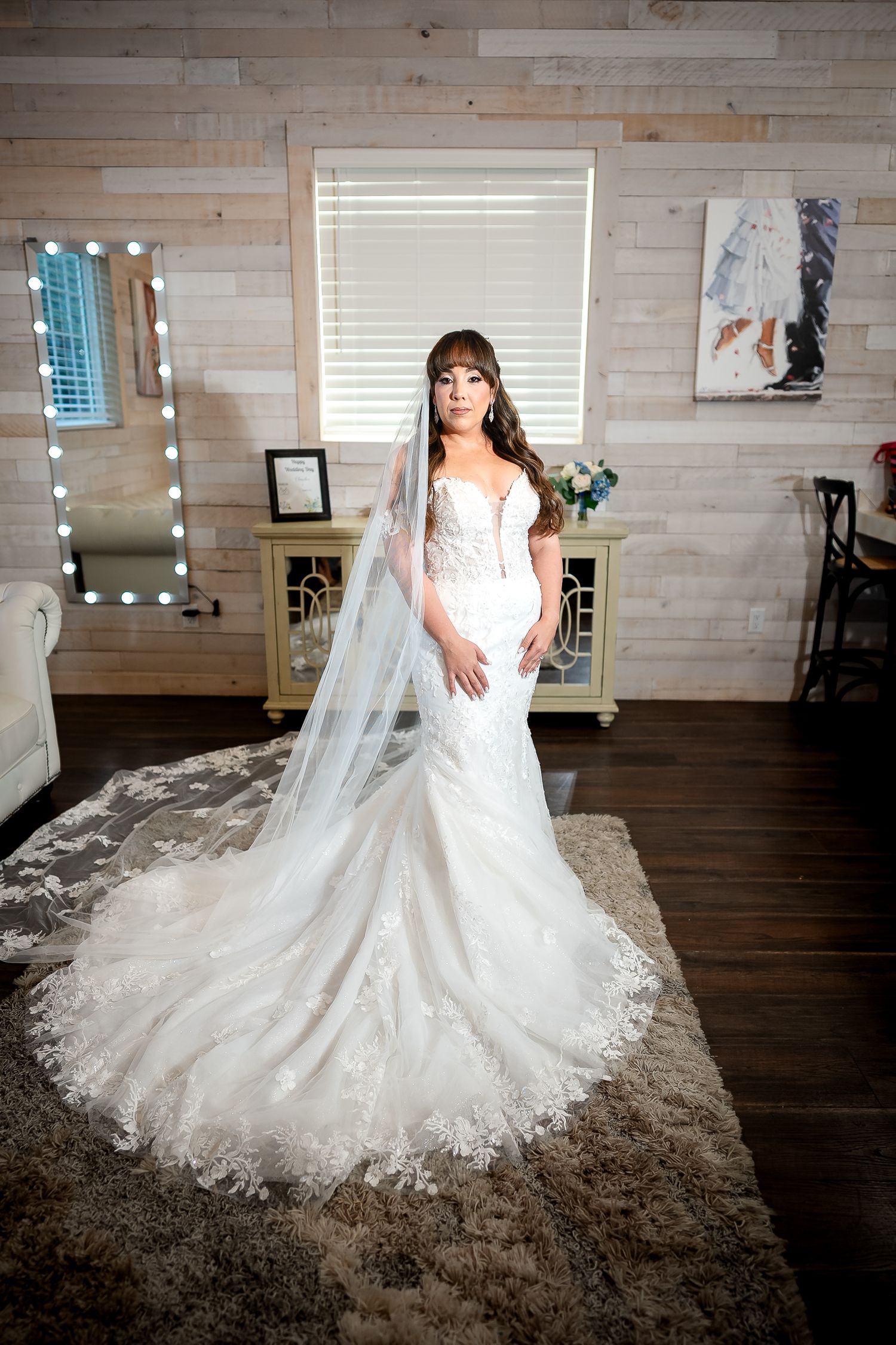 Bride posing indoors in her wedding gown before the ceremony