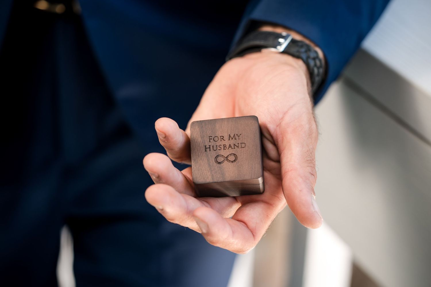 Groom holding a personalized wedding ring box during Florida Keys wedding preparations