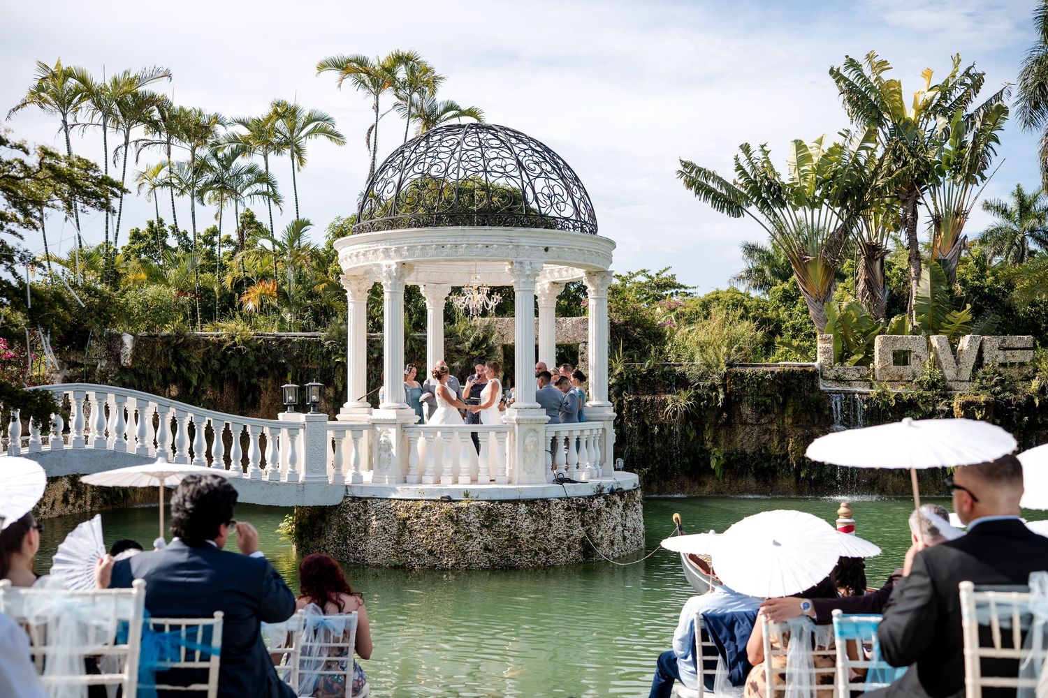 Outdoor wedding ceremony beside a garden gazebo at Little Paradise Farm