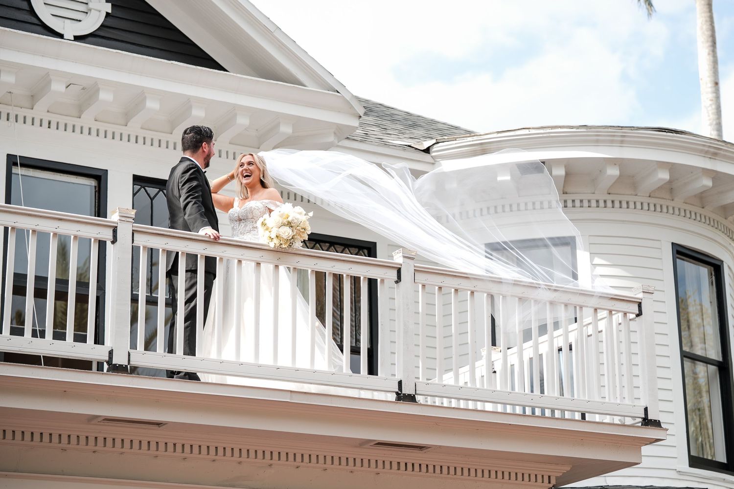 Bride and groom sharing a moment on the balcony of a historic Florida wedding venue