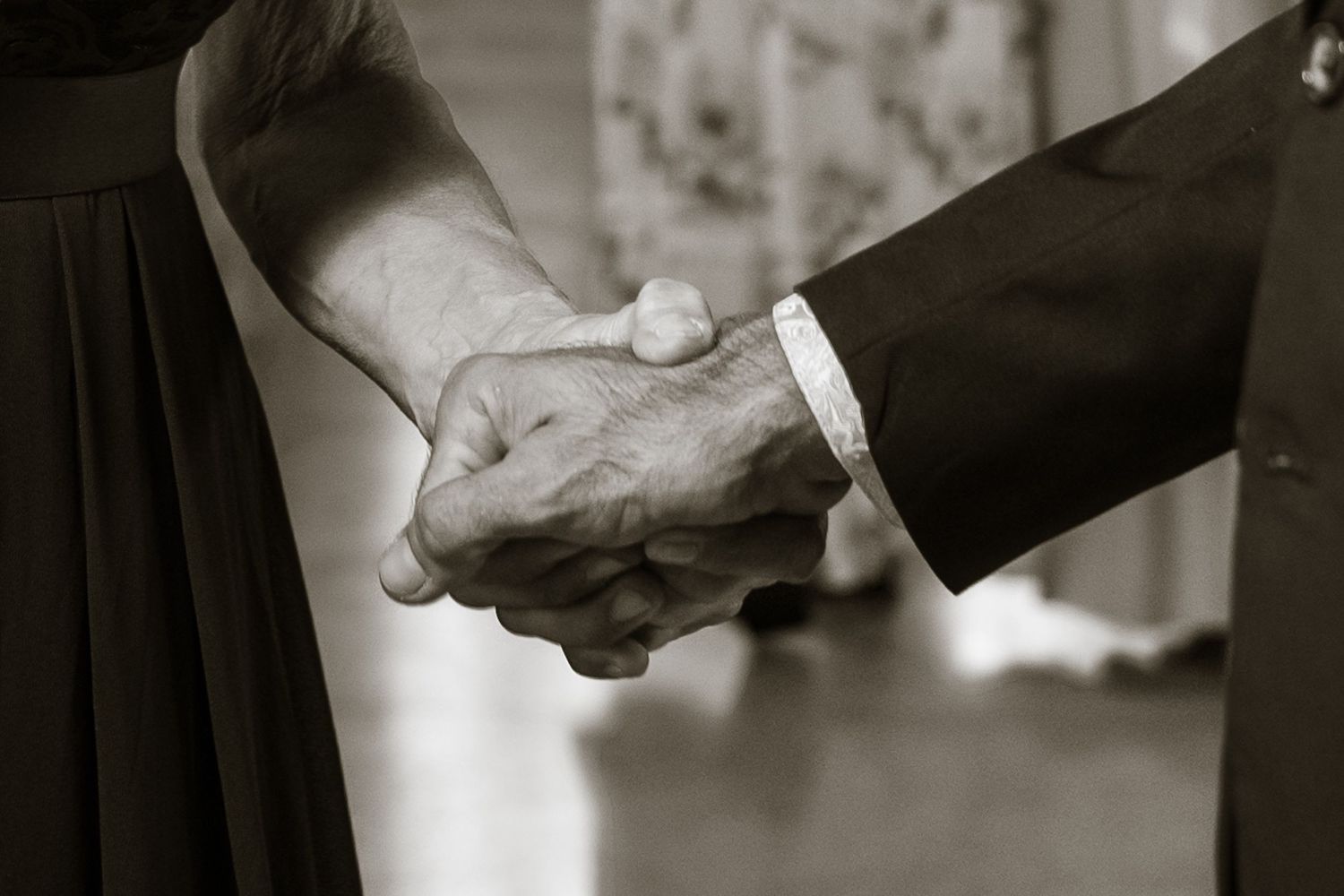 Close-up of hands held together during a Florida Keys wedding ceremony