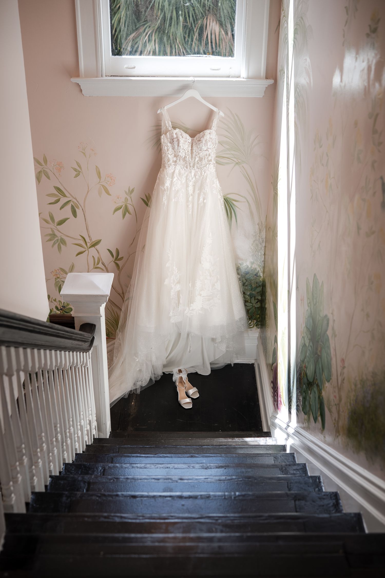 Wedding dress hanging by a window before a Florida wedding ceremony