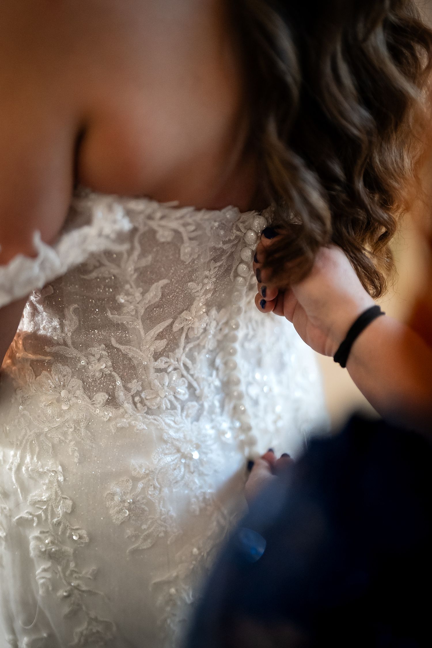 Close-up bridal portrait highlighting lace details of the wedding dress