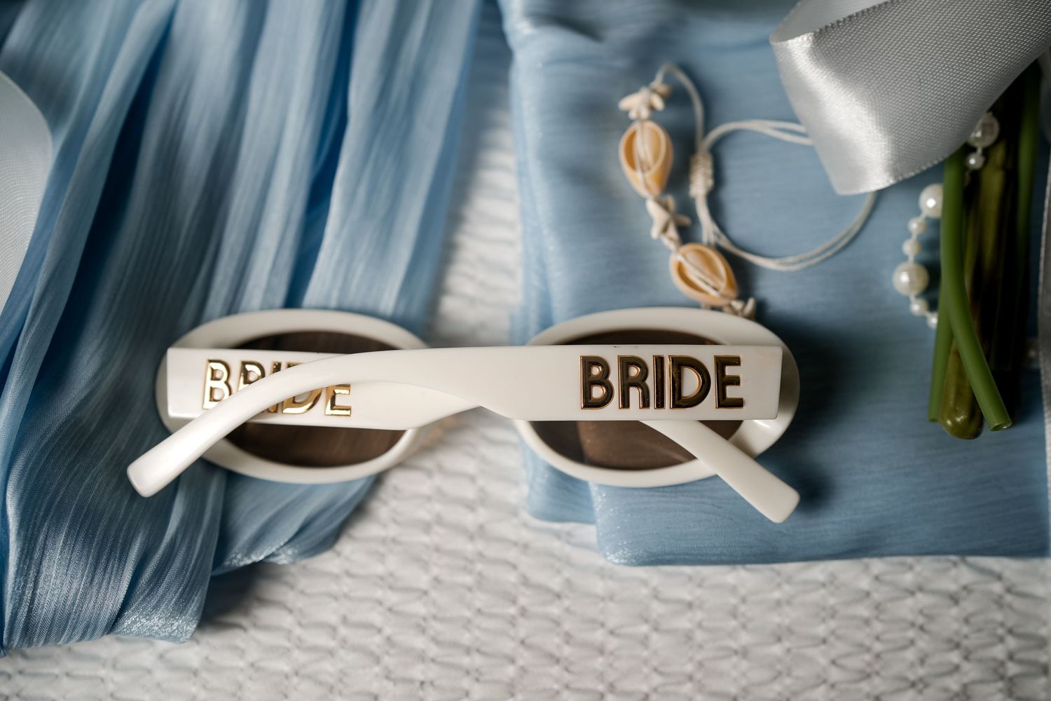 Bride sunglasses and wedding accessories arranged during Florida Keys wedding preparations
