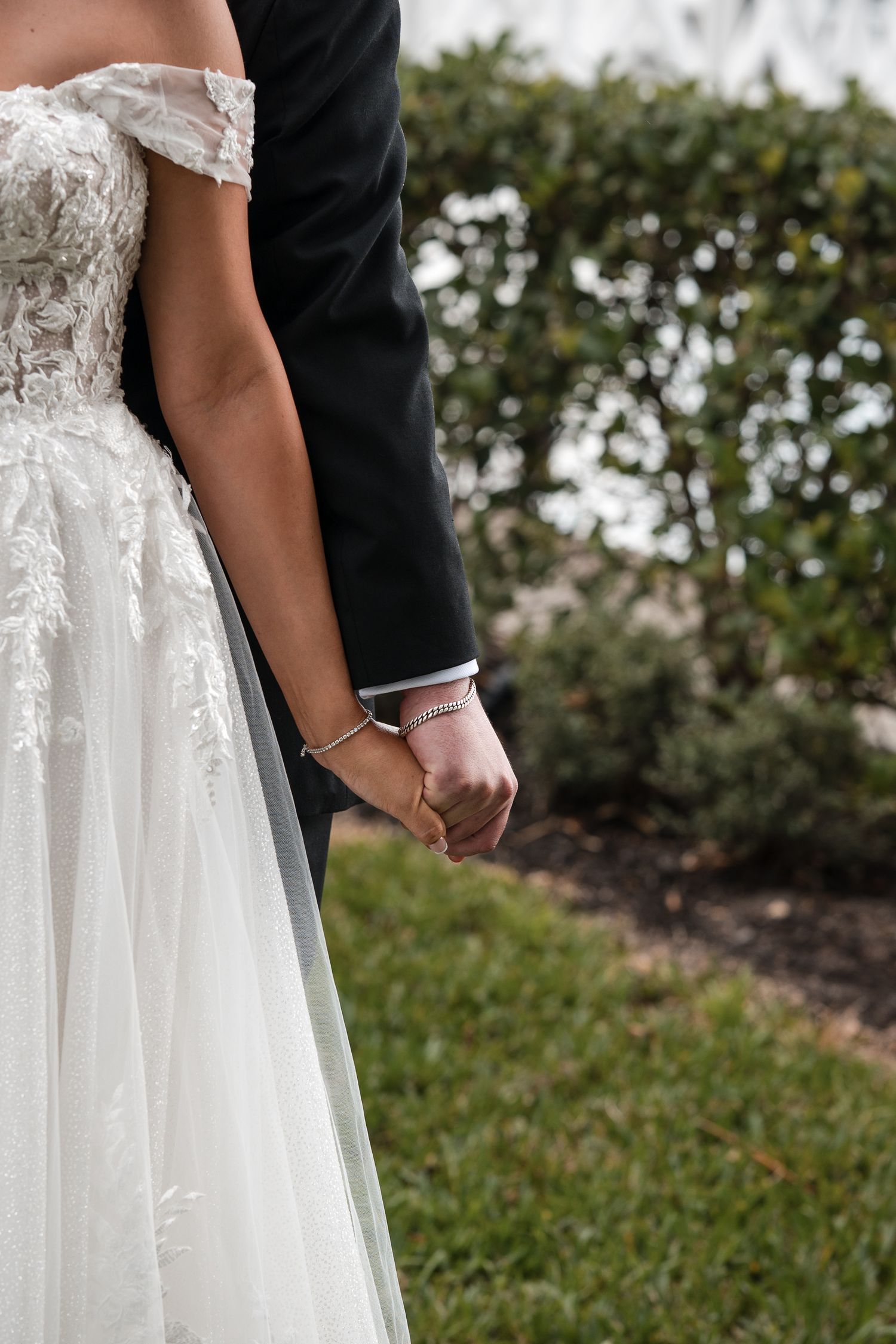 Bride and groom holding hands during their wedding portraits in Florida