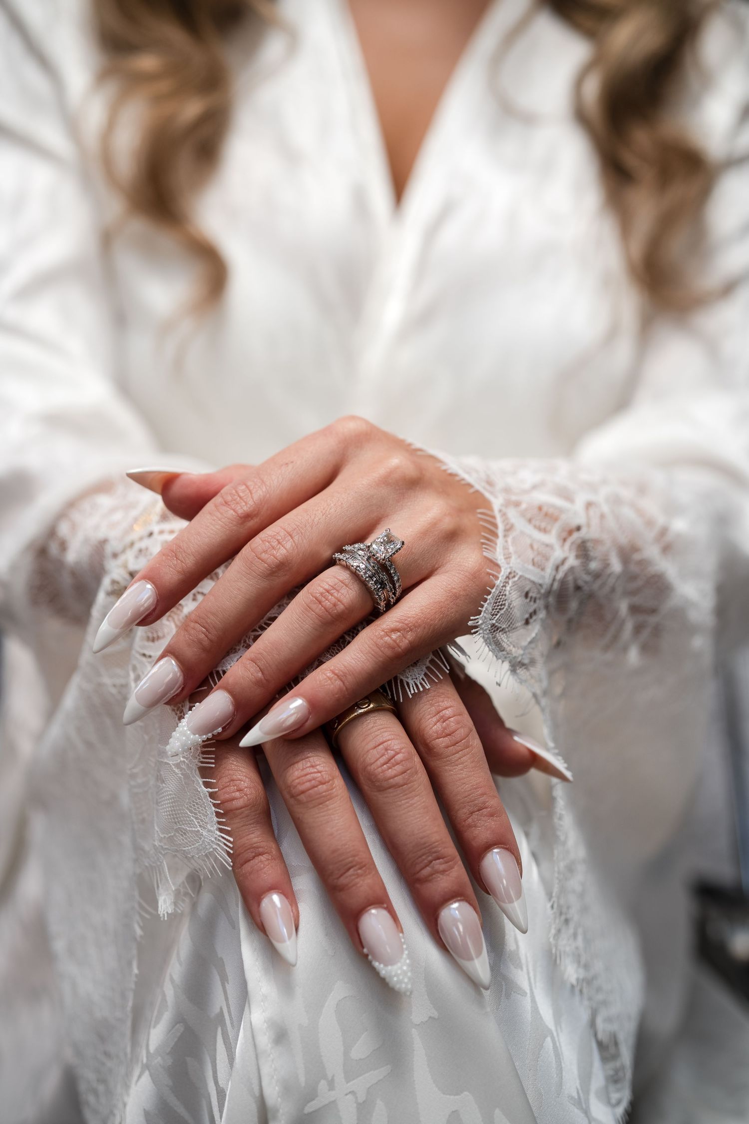 Bride showing her wedding ring during bridal preparations
