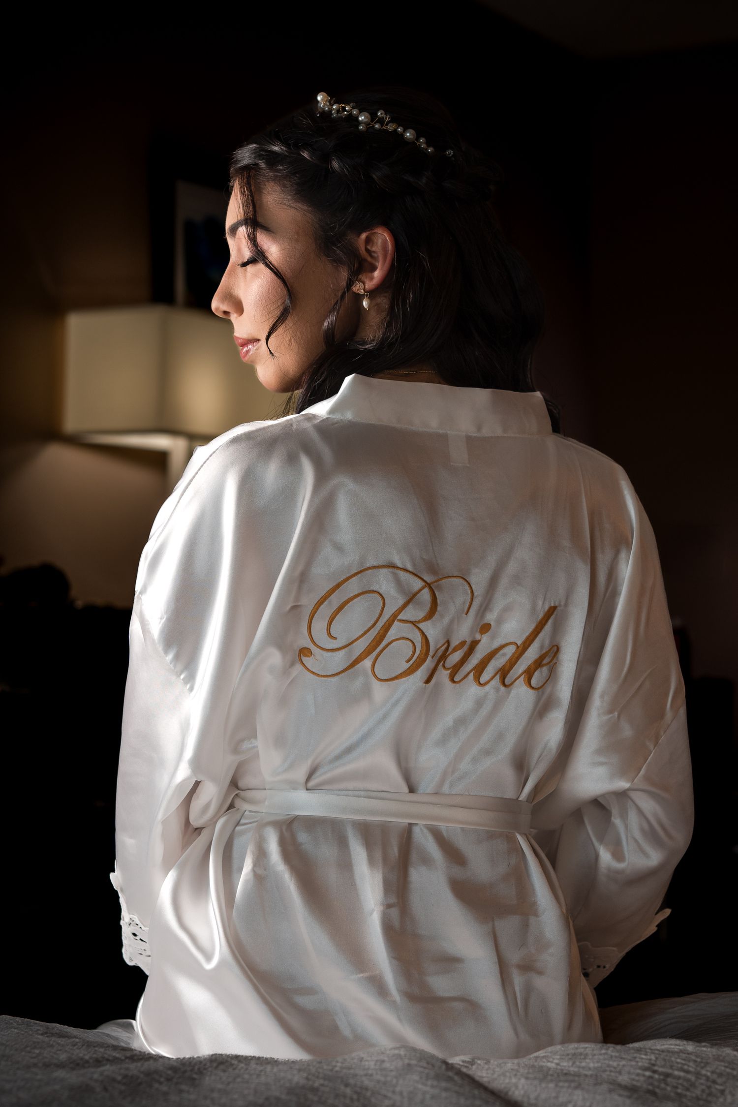 Bride getting ready in a personalized robe before her Miami wedding