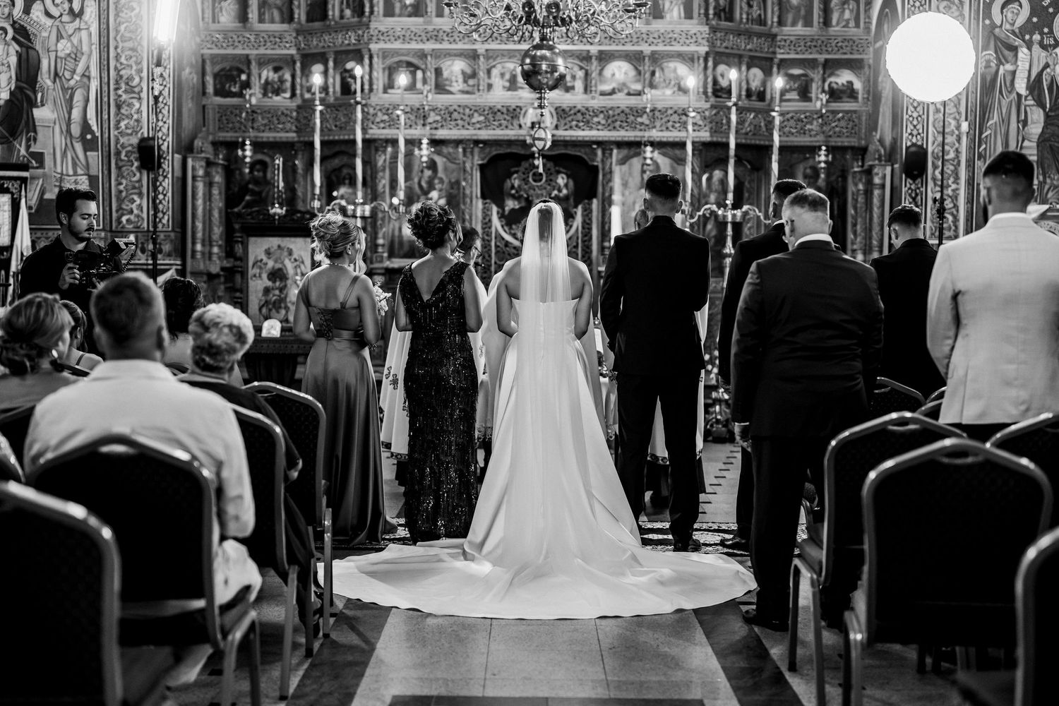 Black and white photo of a bride and groom at the altar during a traditional church wedding ceremony.