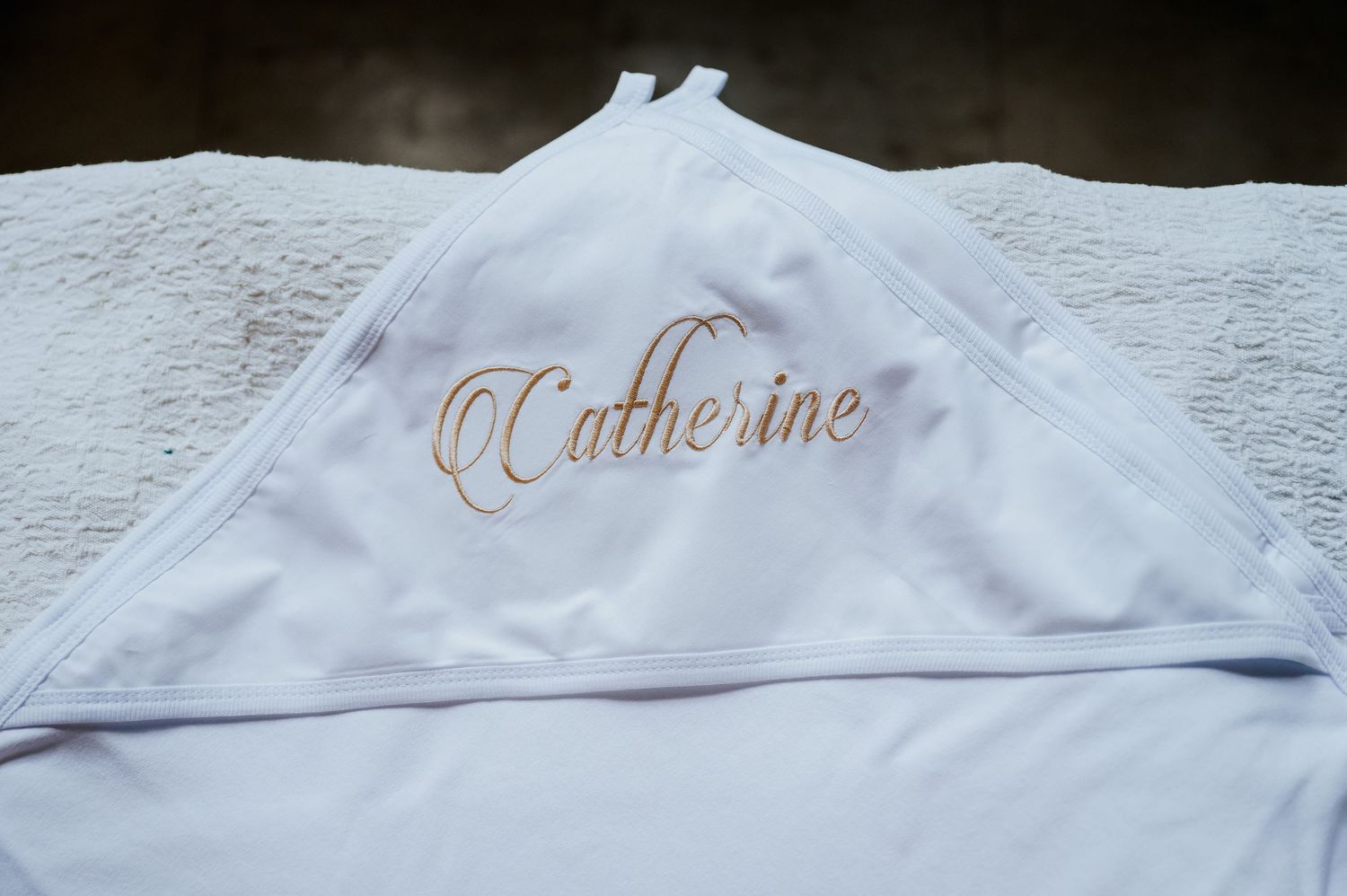 White personalized hooded towel embroidered with the name Catherine in elegant gold script lettering.