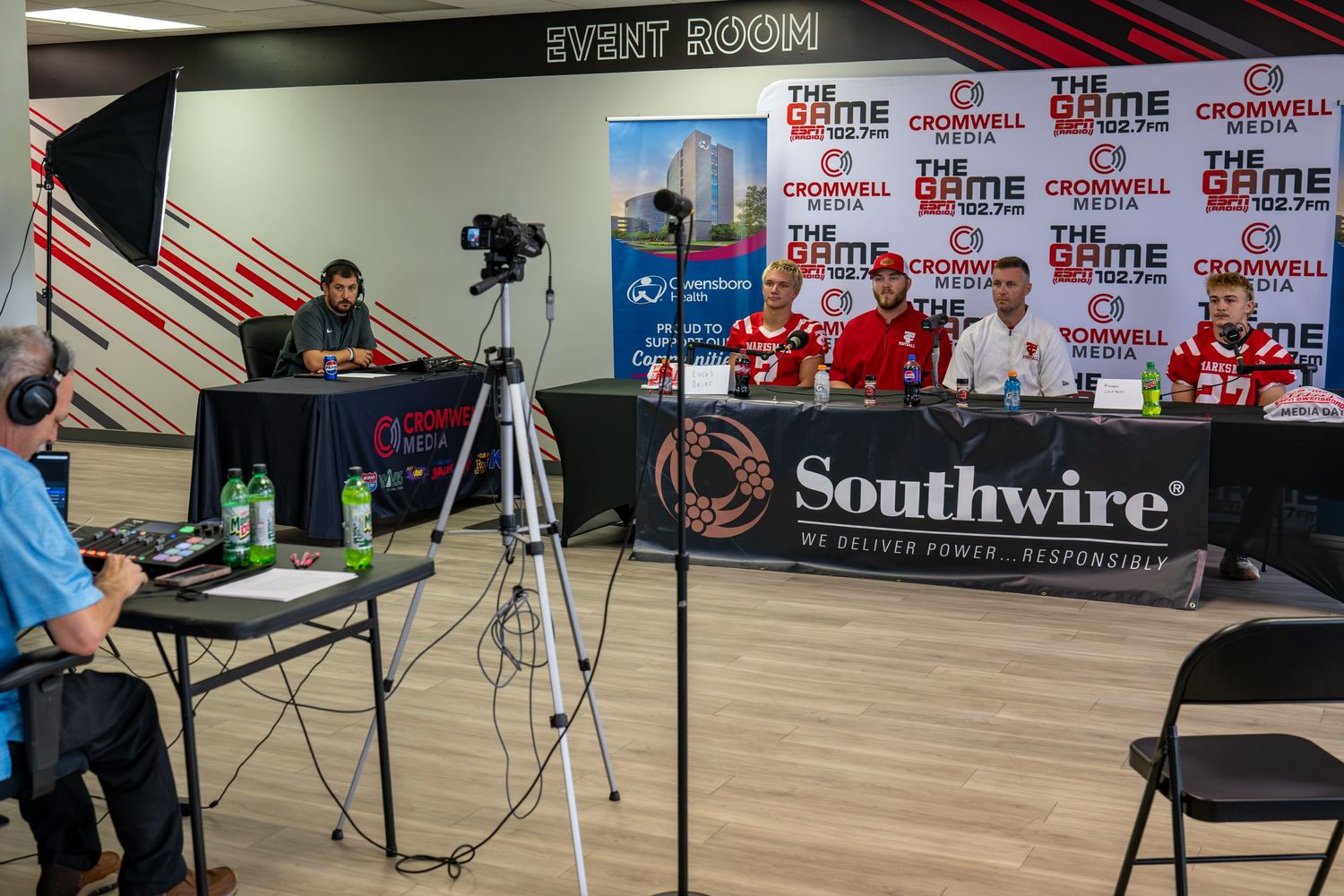 Athletes and coaches sit at a Southwire-sponsored sports press conference table at Cromwell Media Owensboro.