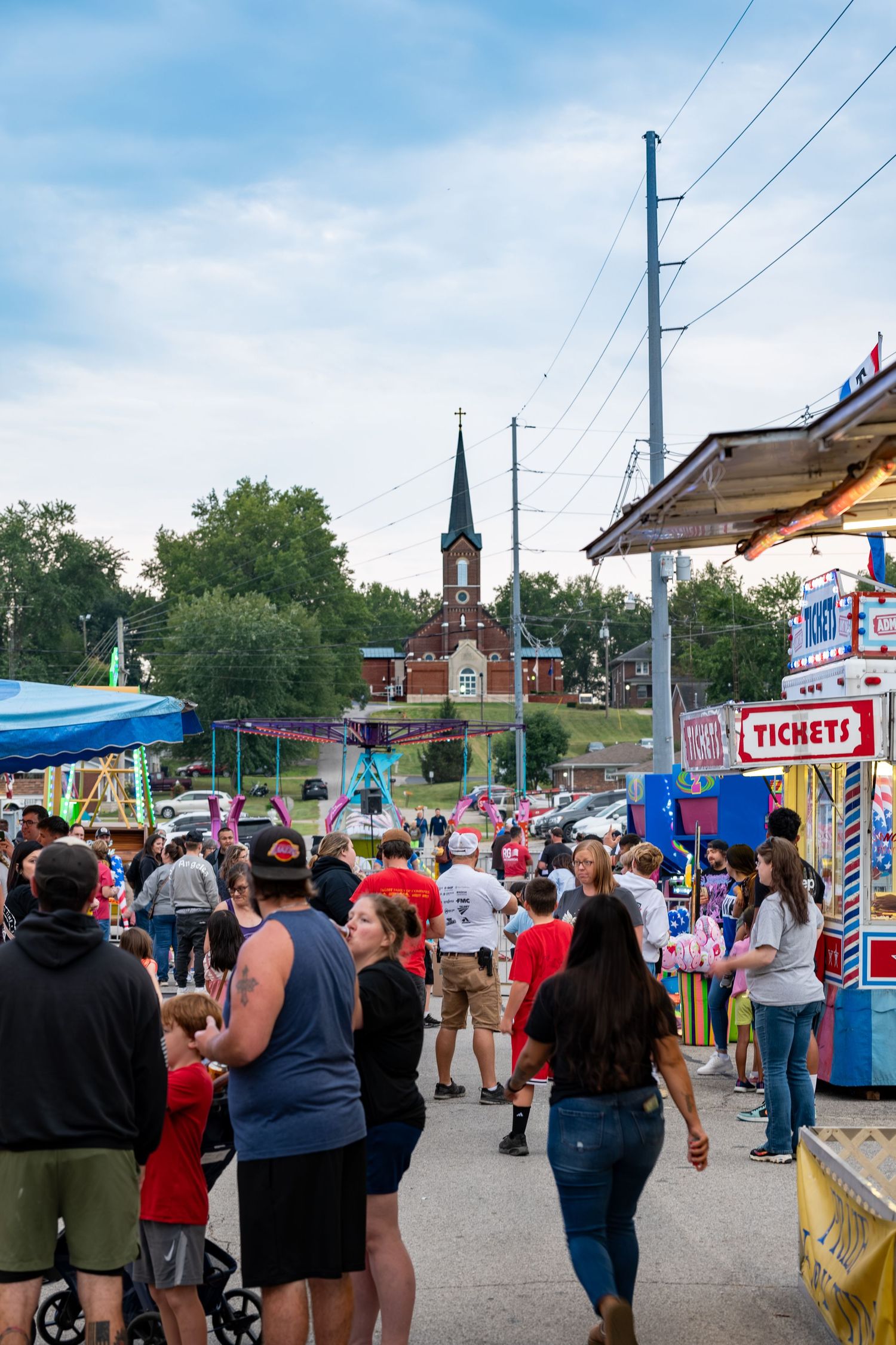 Dale Fall Fest with rides, ticket booth, and church steeple visible in background.