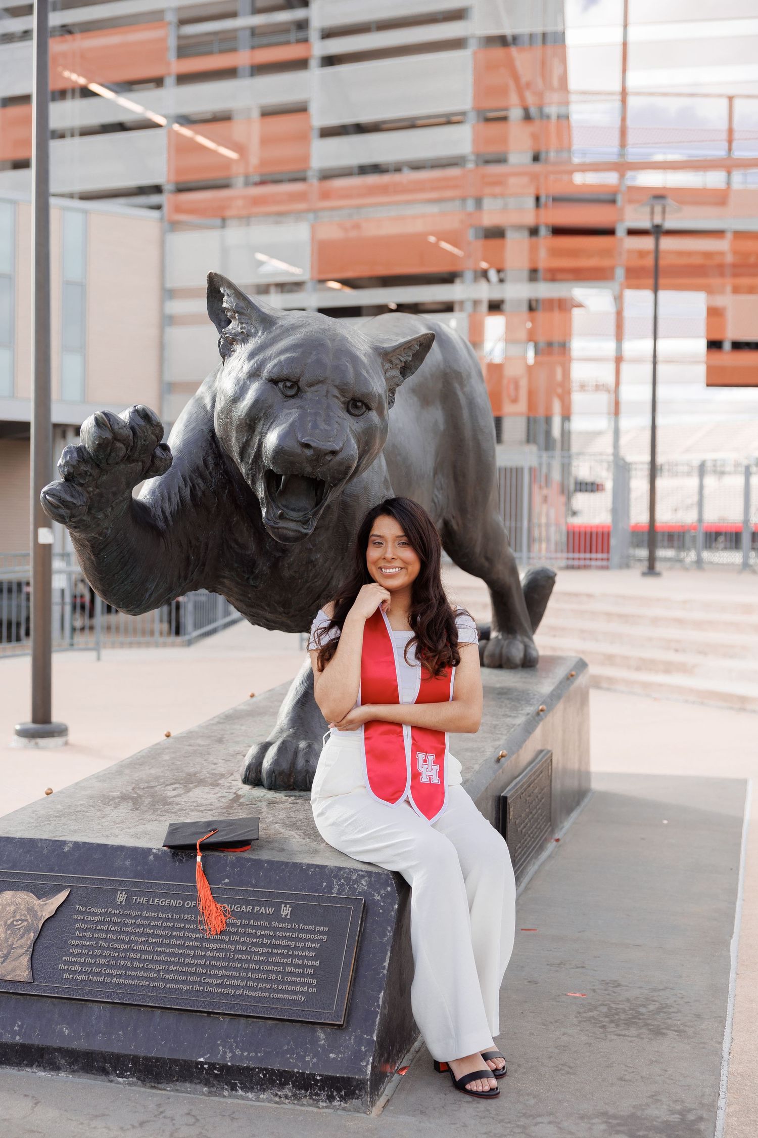 Four photos showing sculpture of Shasta the UH cougar mascot at University of Houston campus with visitor.