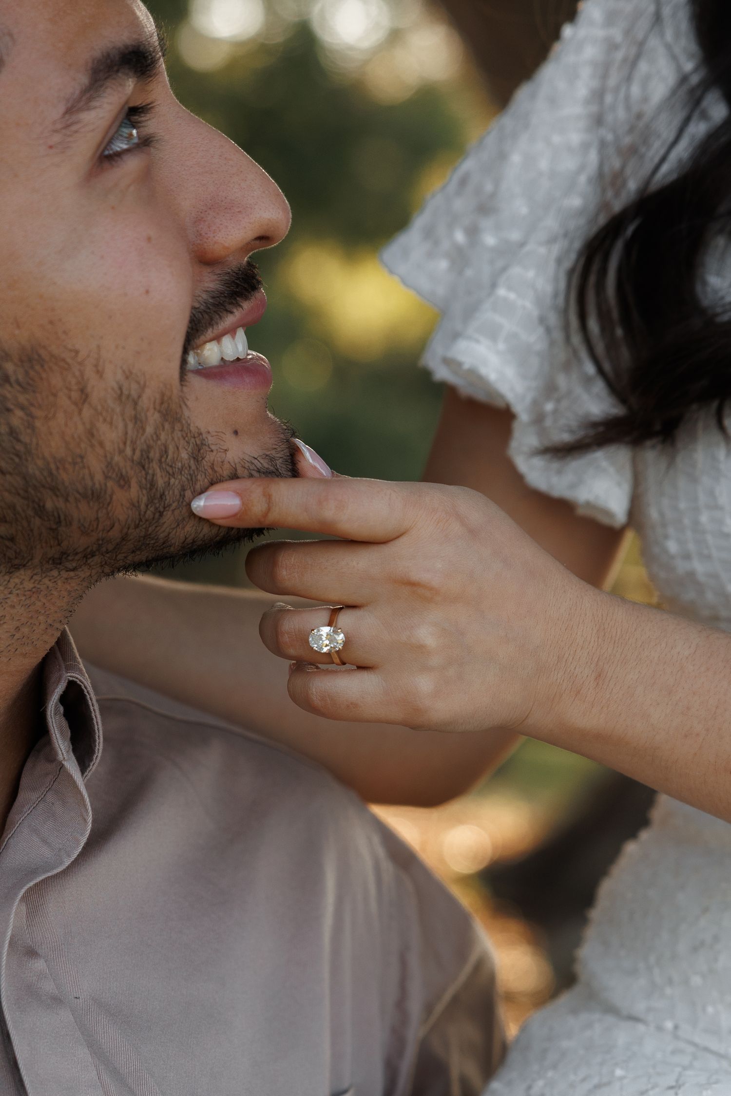 A romantic sequence of a couple in wedding attire sharing a tender moment outdoors with soft bokeh lighting.