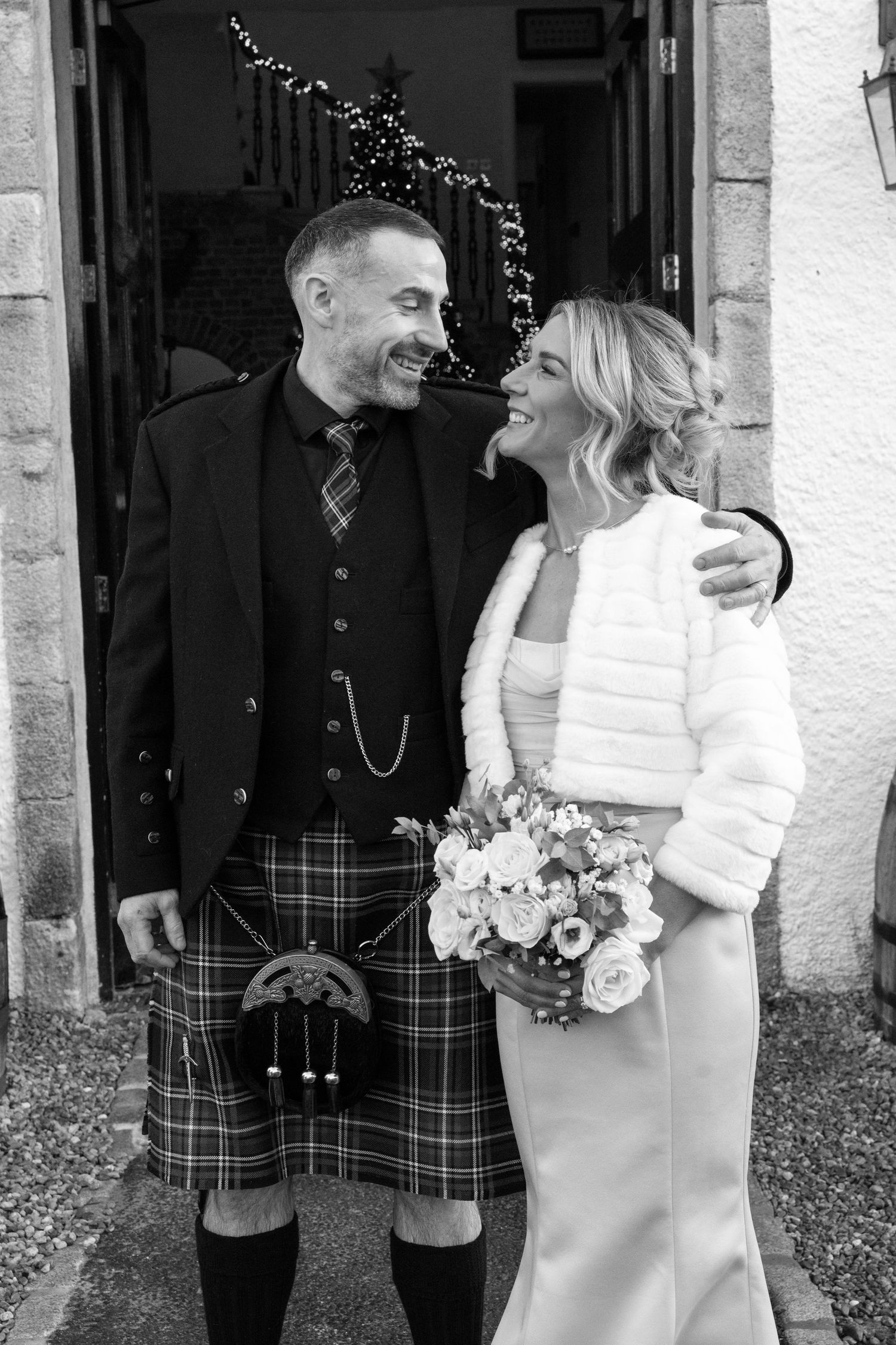 Black and white candid wedding photos showing Scottish formal attire and joyful moments.