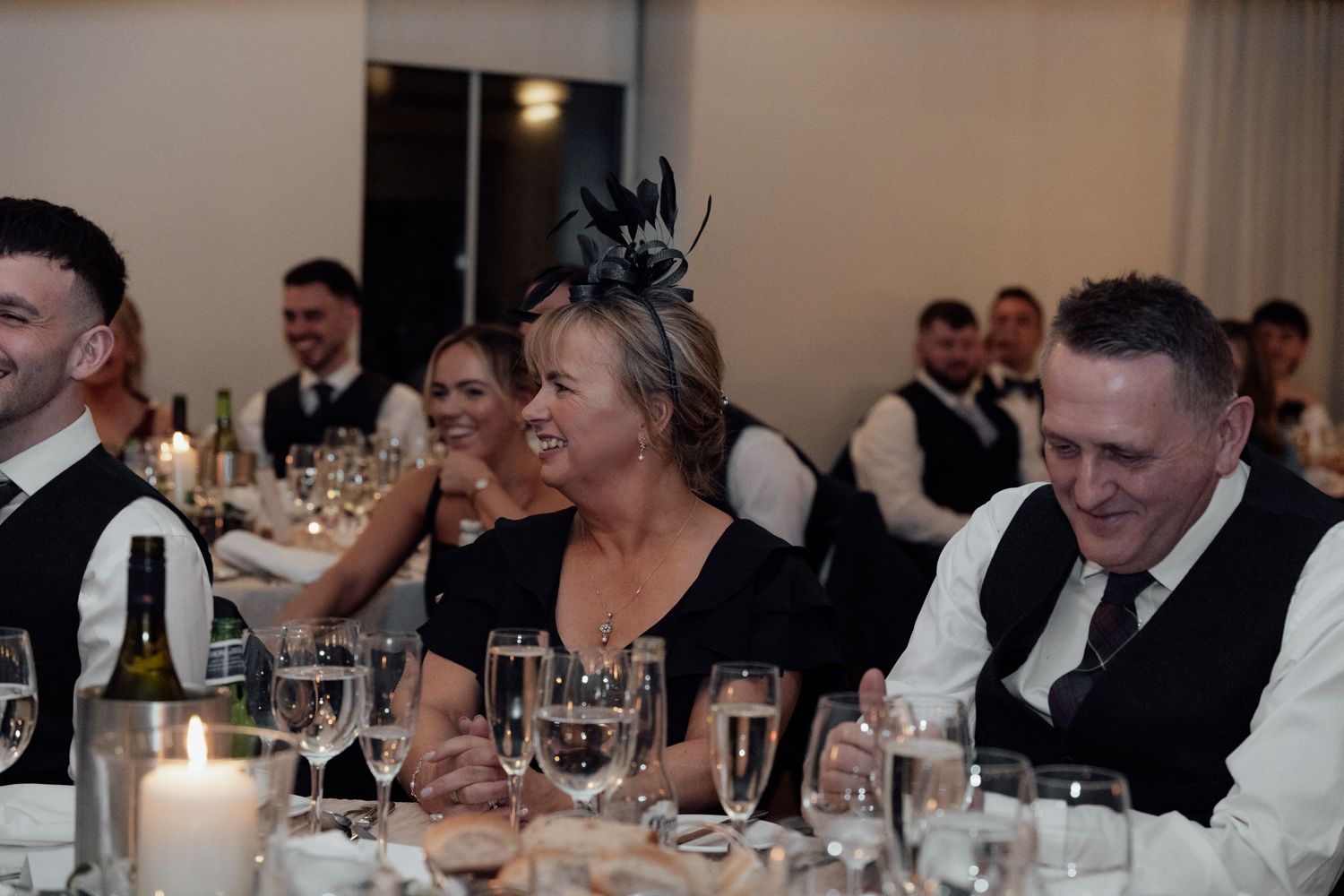 Guests enjoying conversation at an elegant wedding reception dinner.