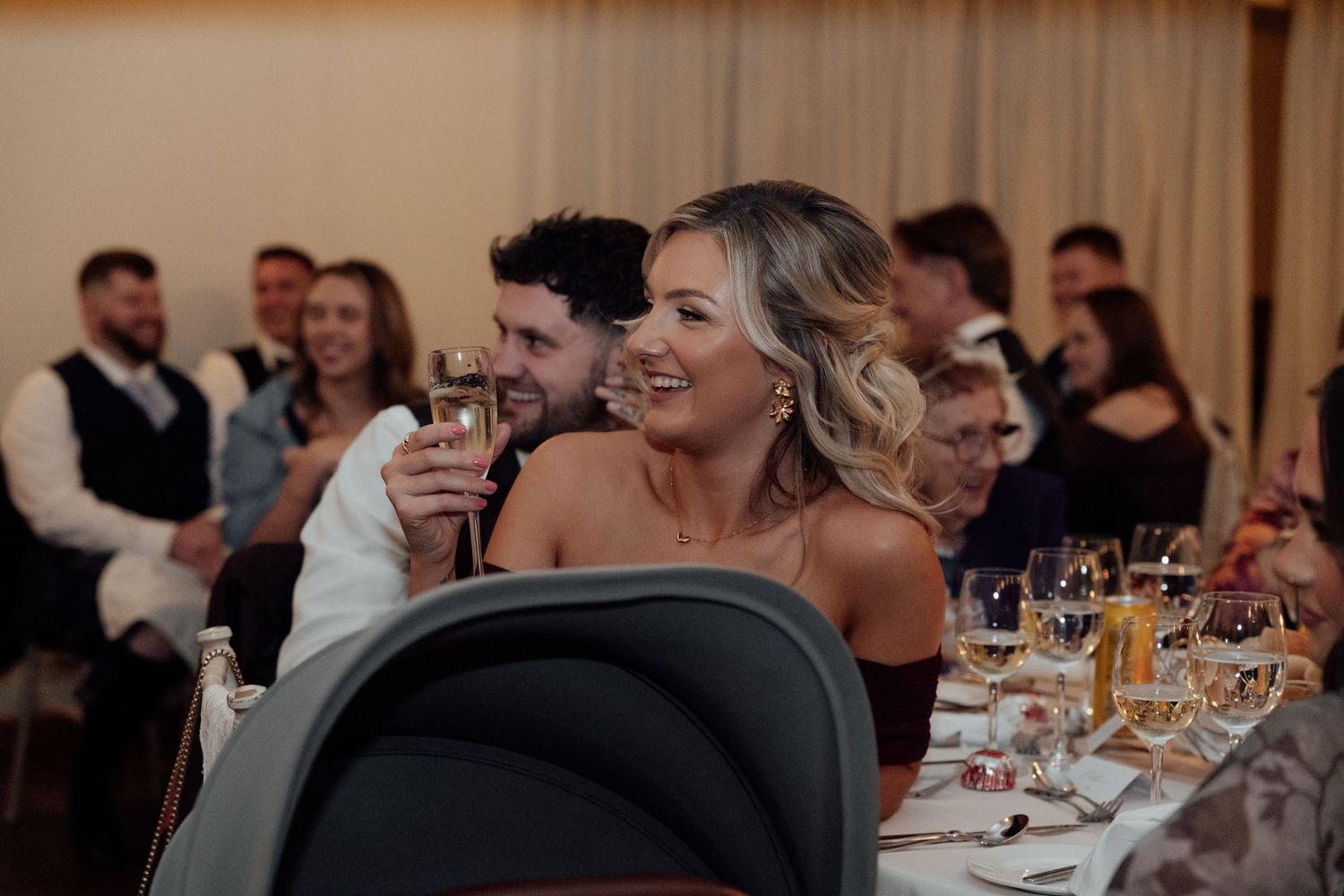 Wedding reception guests enjoying dinner and entertainment in an elegantly decorated venue.