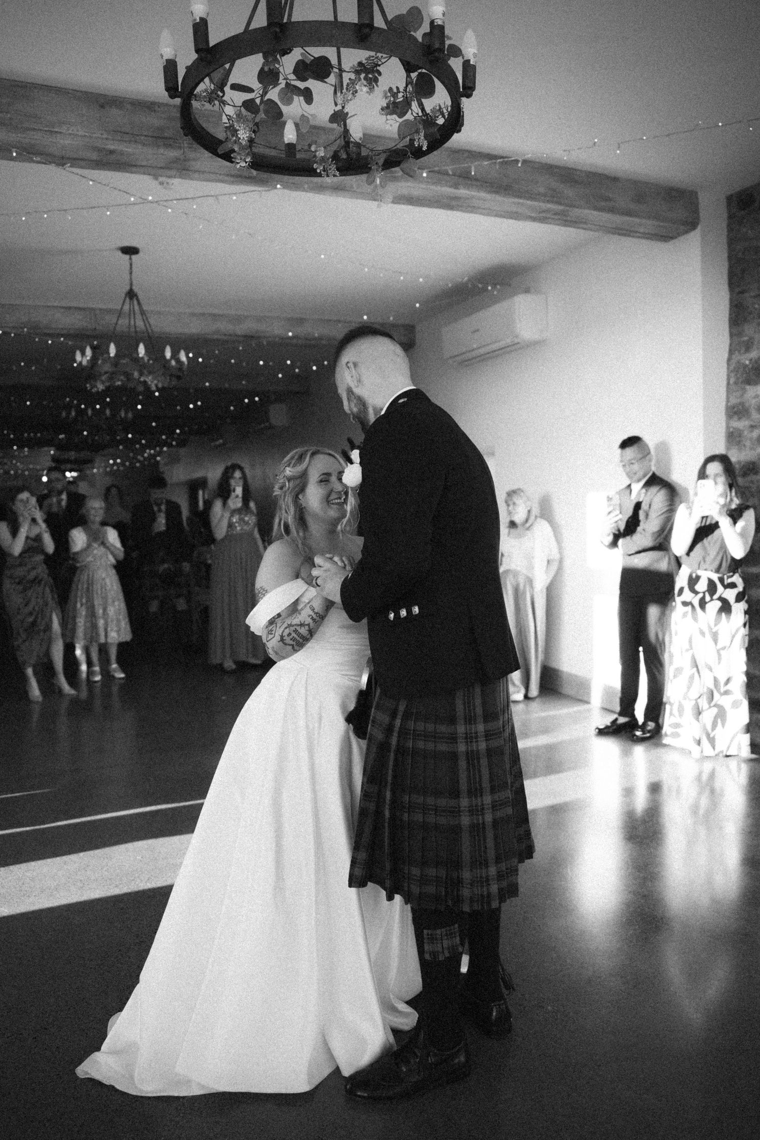 Bride and groom sharing their first dance in black and white at their Scottish wedding reception.