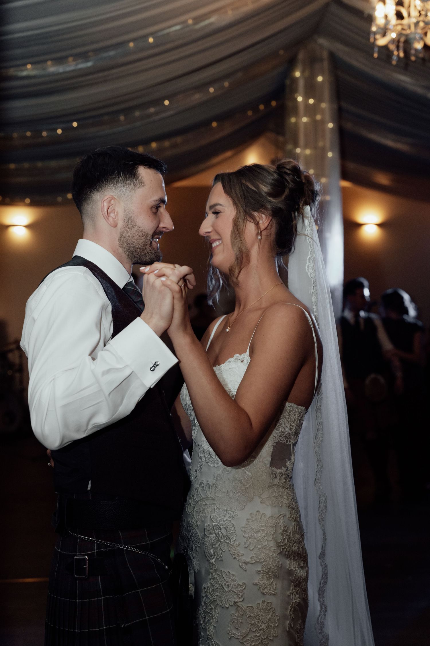 A romantic dance between newlyweds in a beautifully decorated reception venue.