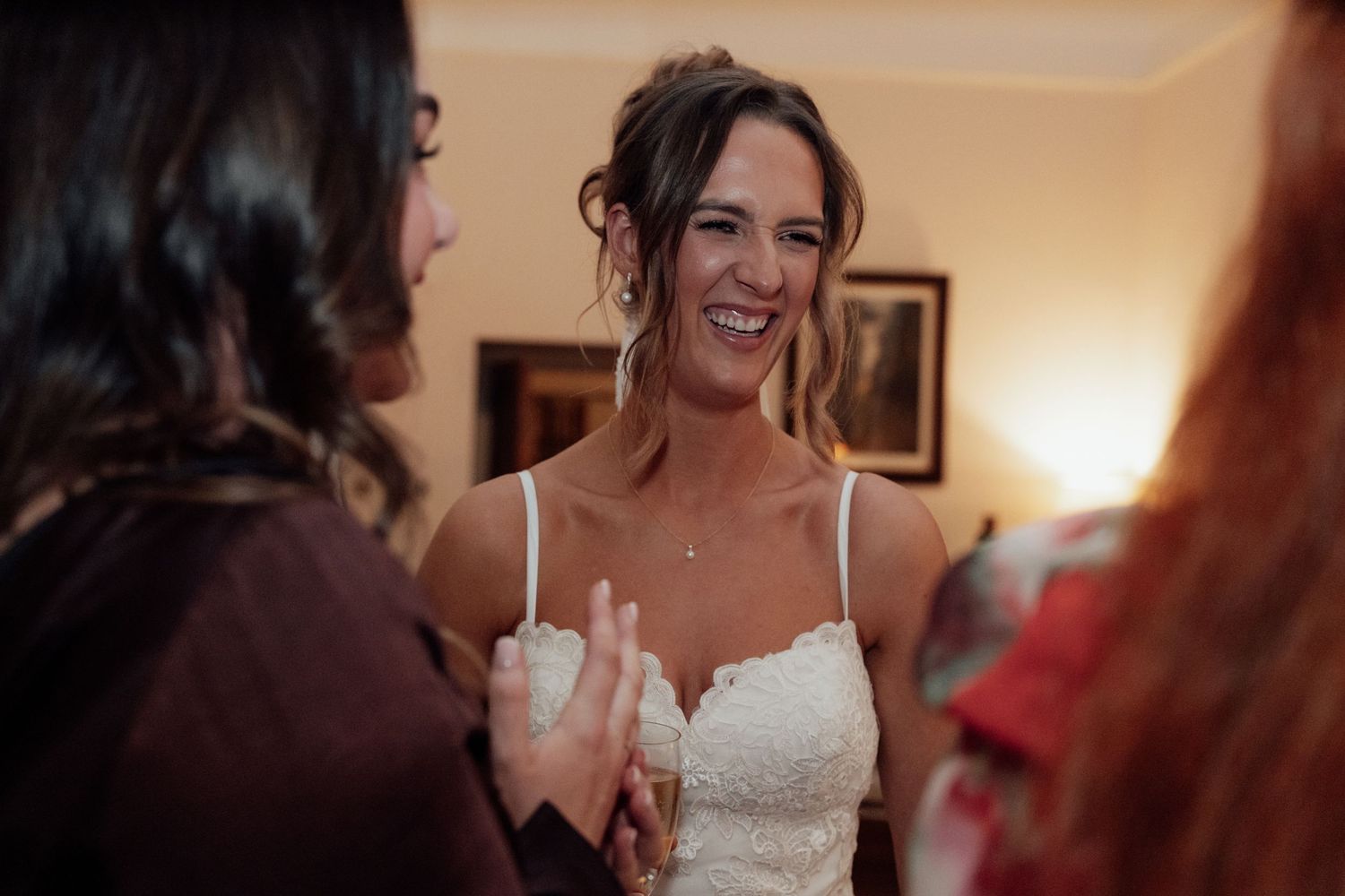 Candid moments of celebration captured during an indoor wedding reception.