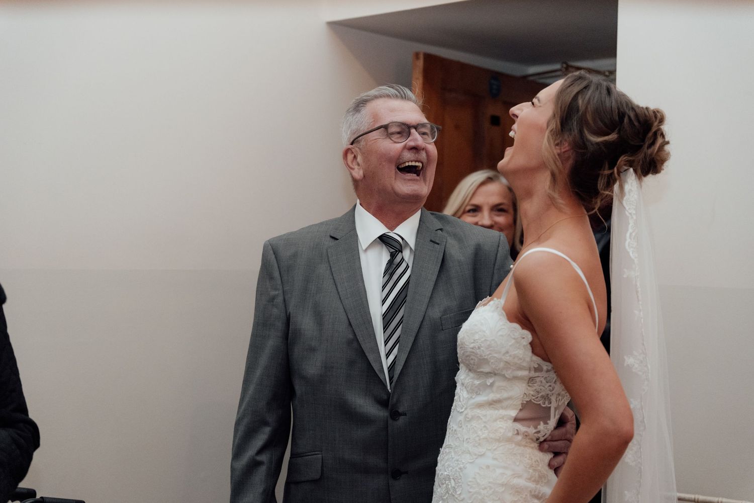 Emotional reactions captured between guests during a wedding celebration.