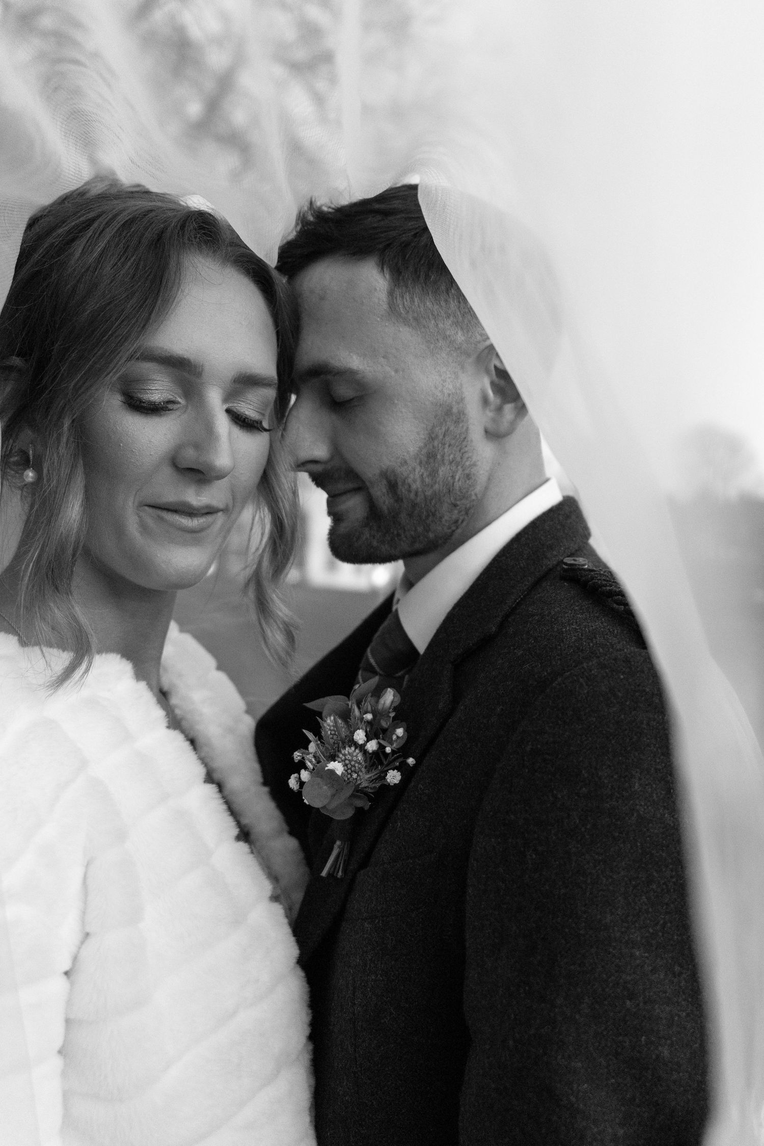 Intimate black and white wedding portraits showing tender moments between the newlyweds.