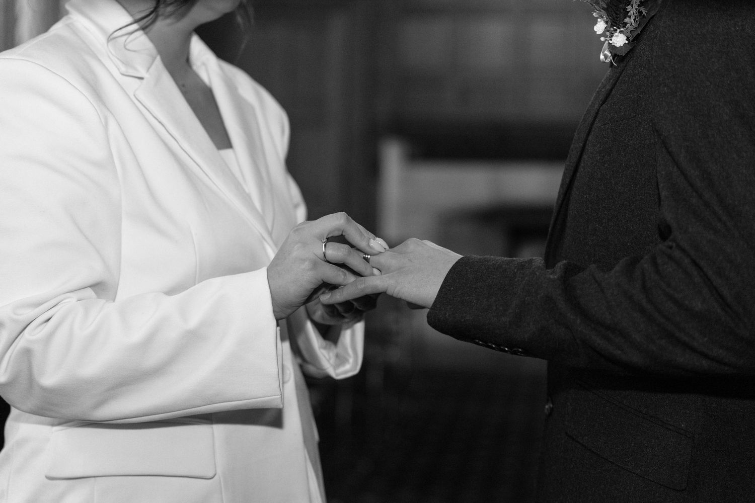 Black and white wedding moment captured with elegant white dress details.