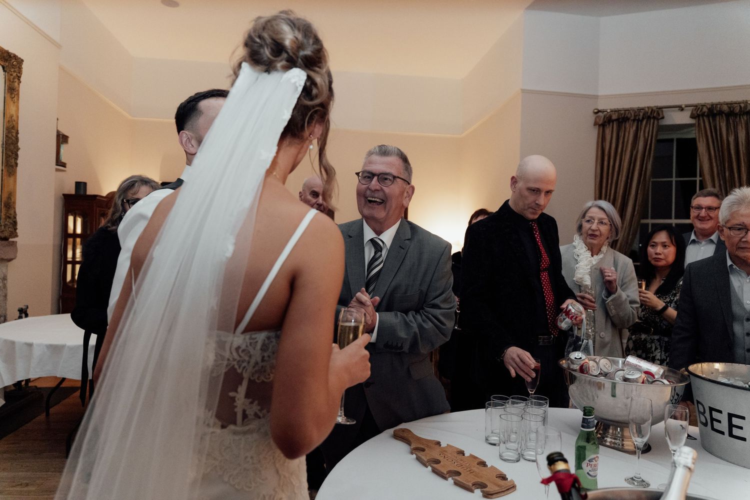 Wedding celebration with guests mingling in a formal indoor setting.